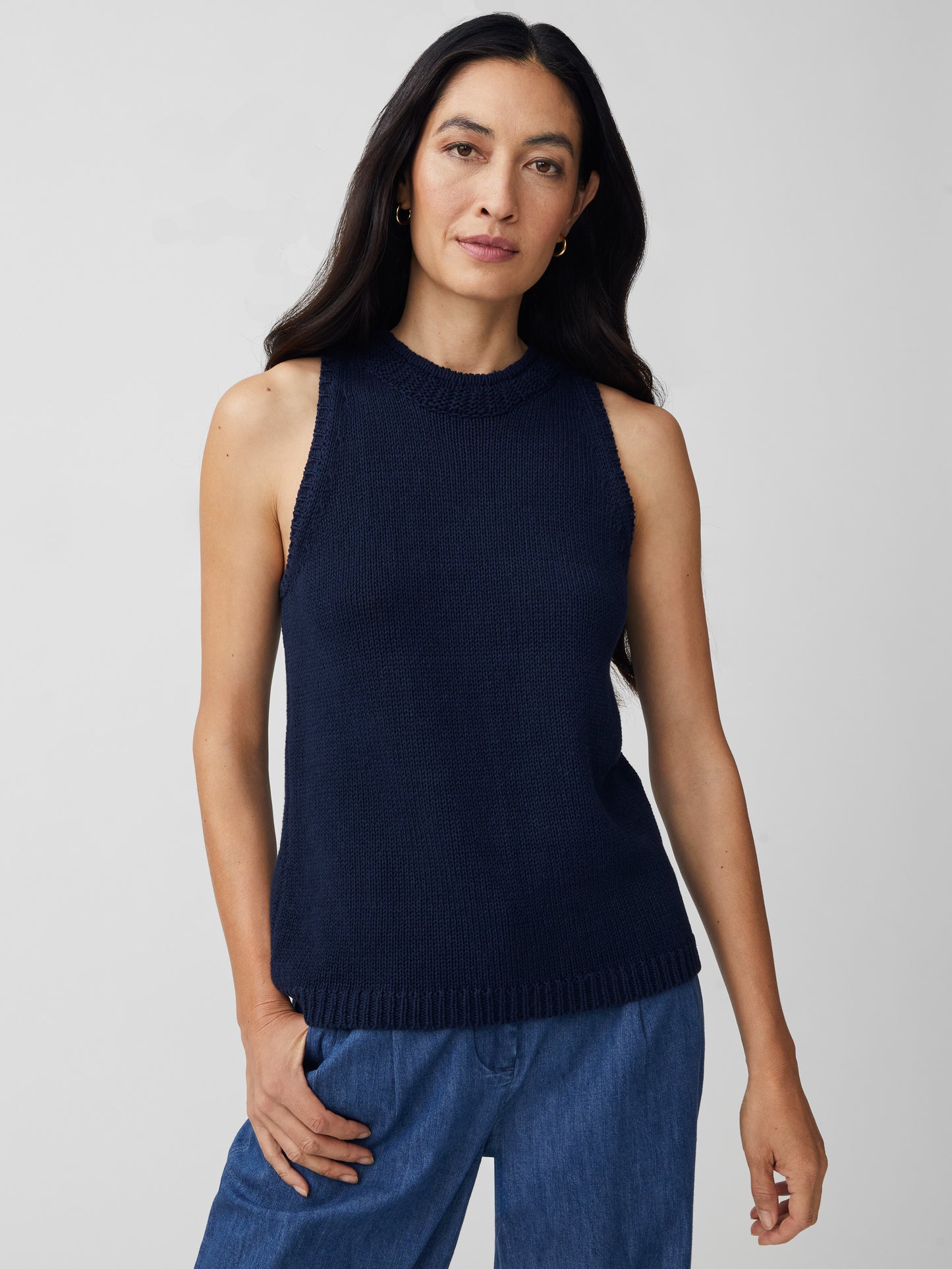 J.McLaughlin model wears Felicity Sleeveless Sweater in navy made with cotton/linen.