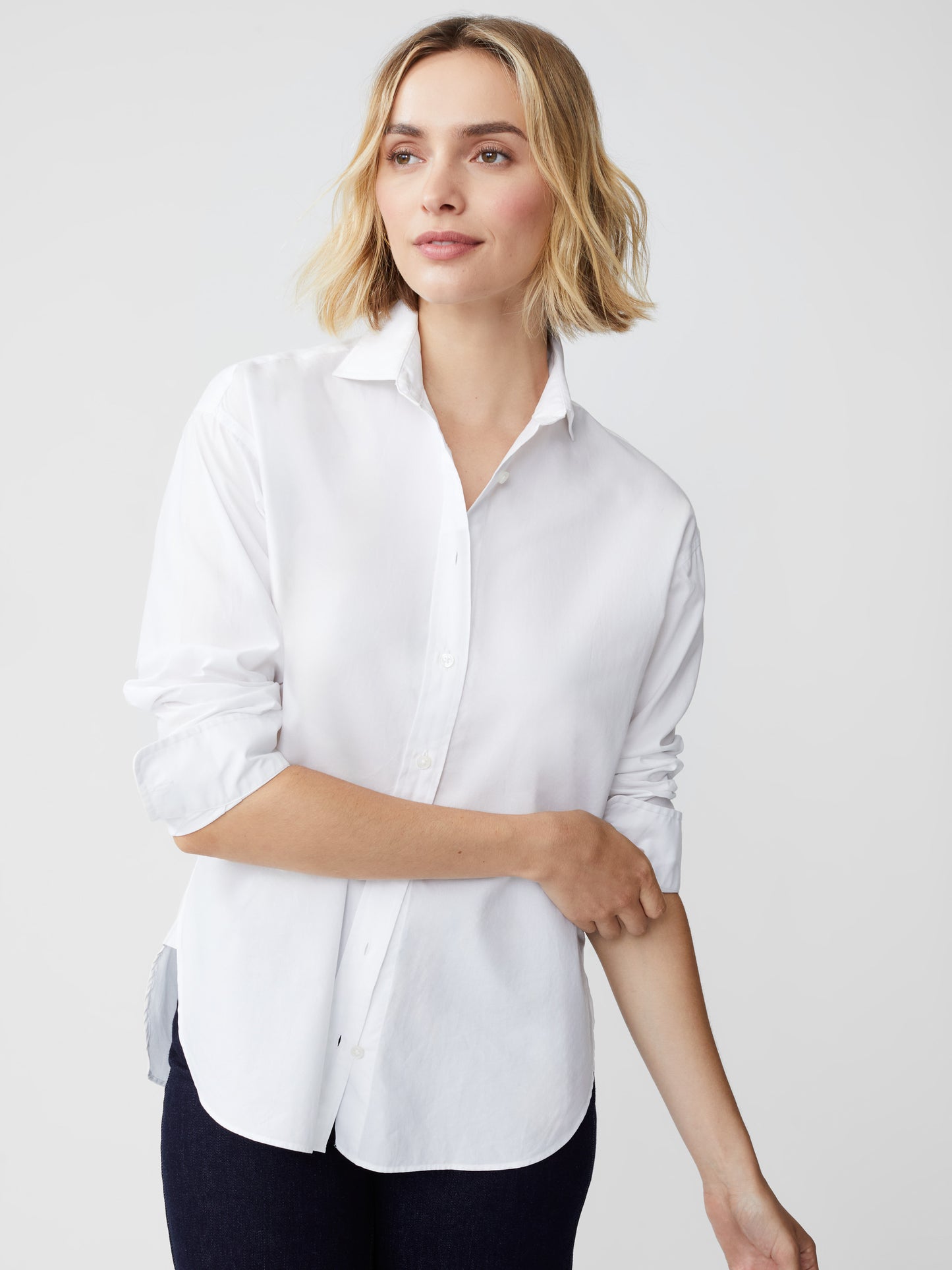 Model wearing J.McLaughlin Finn shirt in white made with cotton/modal.