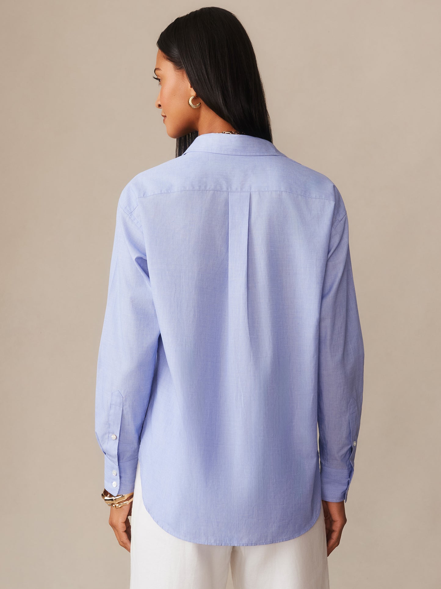 Back view of a woman wearing a light blue Finn Shirt by J.McLaughlin, showcasing effortlessly stylish design and innovative fabrics for enduring style.