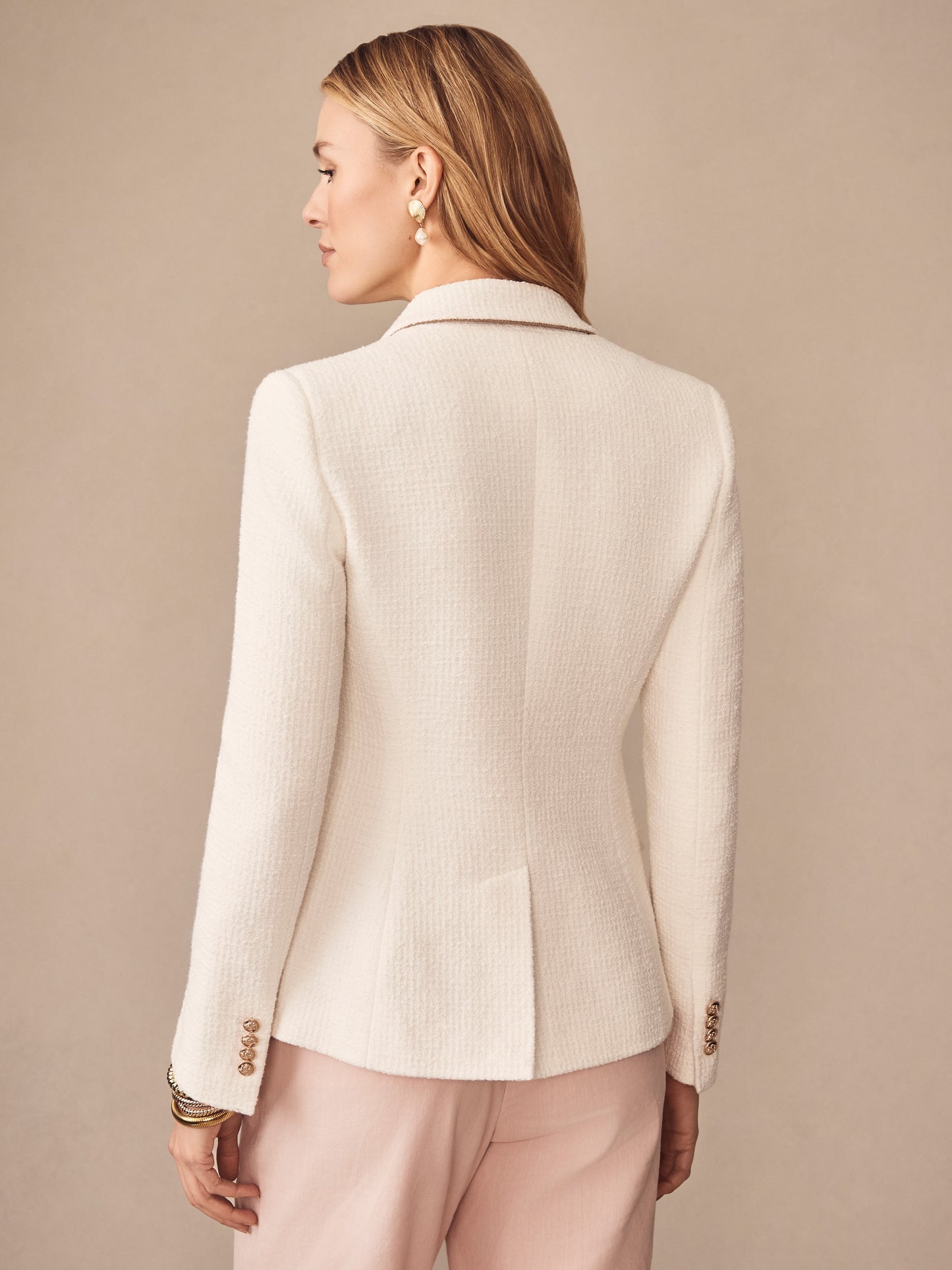 A woman models the Genevieve Cotton Bouclé Blazer by J.McLaughlin, featuring effortlessly stylish tailoring in a soft, textured fabric that embodies enduring designs and a legacy of timeless fashion. A destination for defining style. Life, Well-Lived.