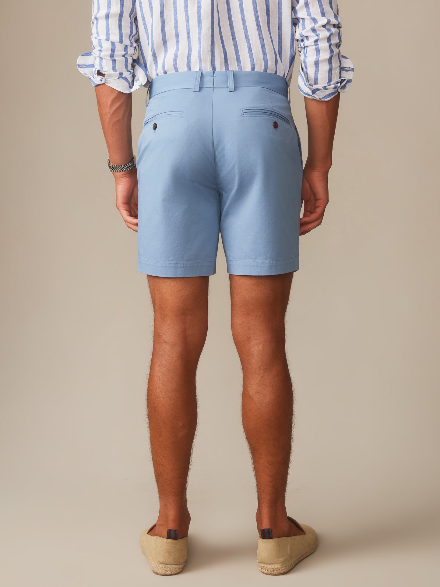 Man wearing light blue Chatham Shorts by J.McLaughlin paired with a striped shirt, showcasing effortlessly stylish shorts with enduring designs in innovative fabrics, a destination for defining style. Life, Well-Lived.