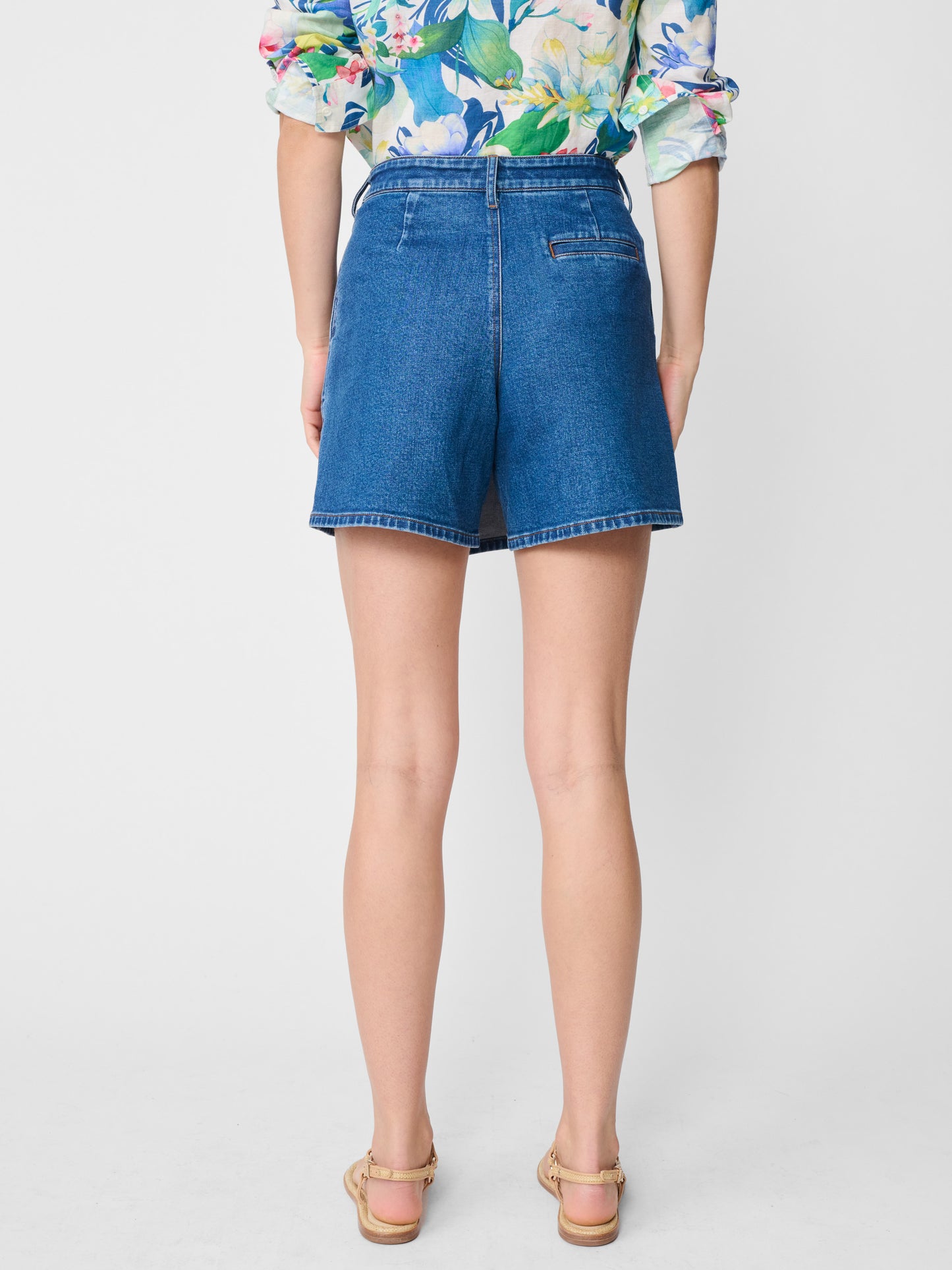 Model wearing J.McLaughlin Gwendoline shorts in medium denim made with cotton.