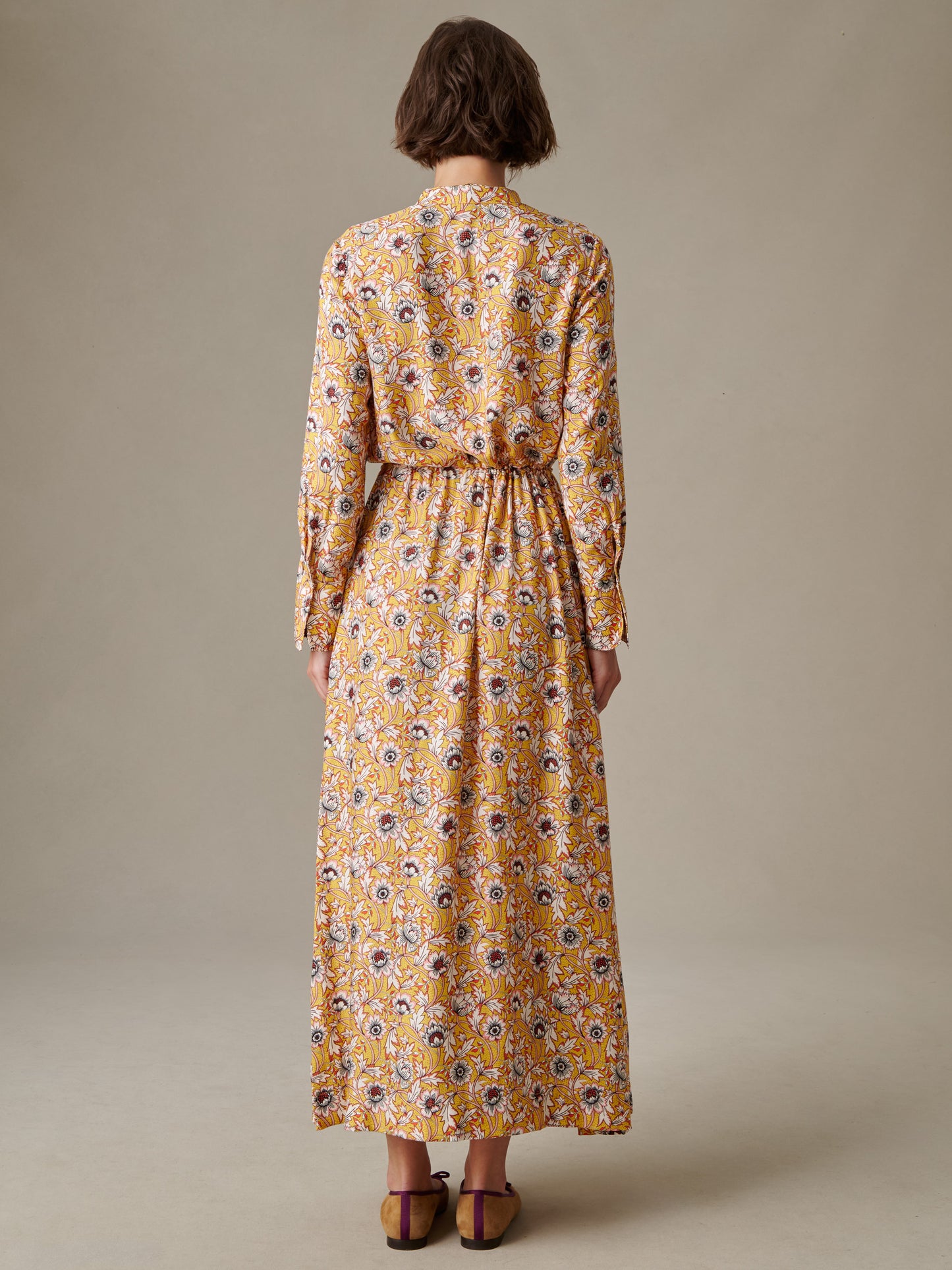 Woman wearing a long-sleeve, floral Hannah Silk Blend Dress in Belle Epoque Bloom by J.McLaughlin, showcasing elegant, enduring design and impeccable craftsmanship.