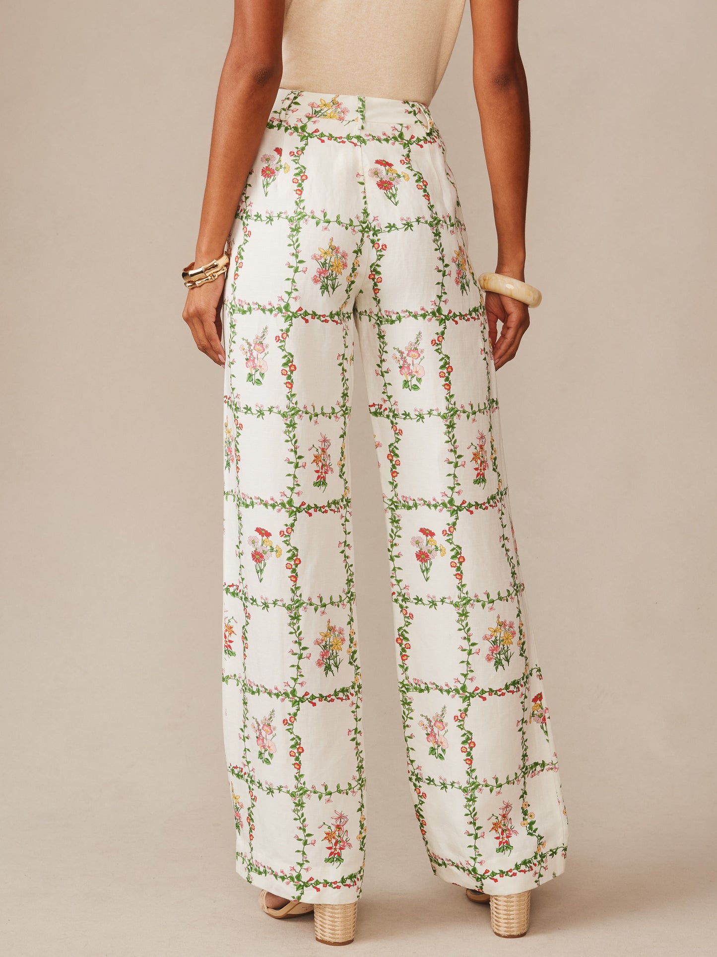 Back view of a model wearing Helen Linen Blend Pants in Floral Medley Frame by J.McLaughlin, featuring an effortlessly stylish, floral print with enduring designs and innovative fabrics, embodying a legacy of timeless fashion. A destination for defining style. Life, Well-Lived.