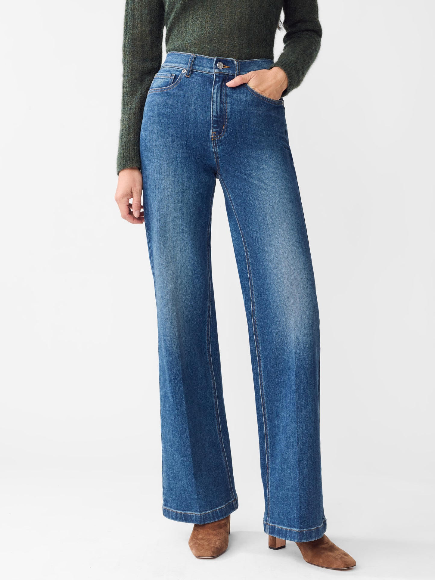 Model wearing J.McLaughlin Lowden jeans in dark indigo made with cotton.