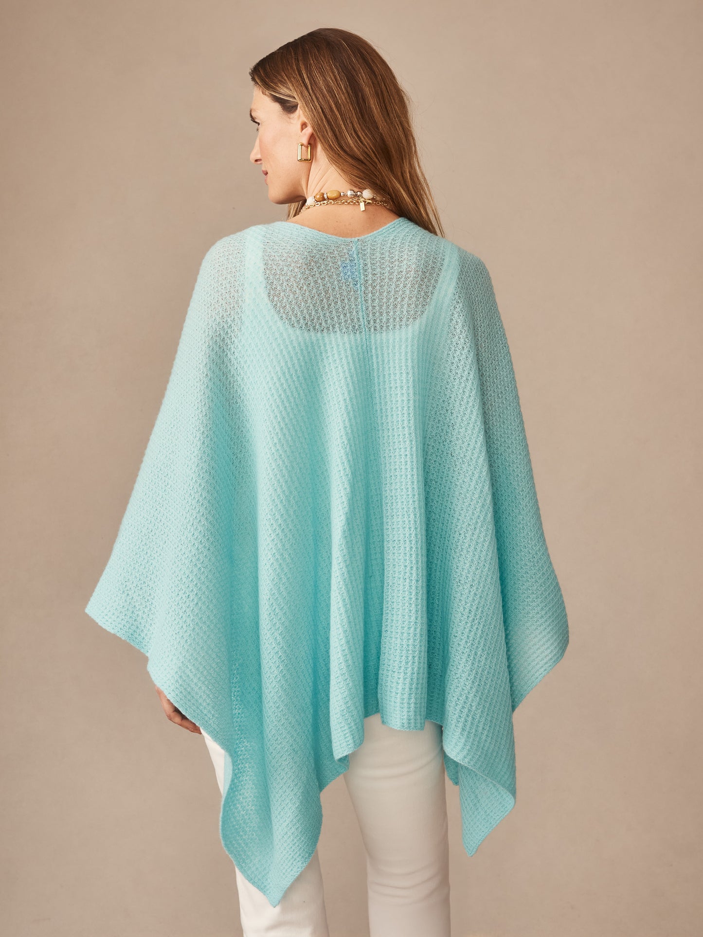 Woman wearing a seafoam green Julianne Cashmere Wrap by J.McLaughlin, showcasing effortlessly stylish, enduring designs and innovative fabrics in a timeless, classic look.