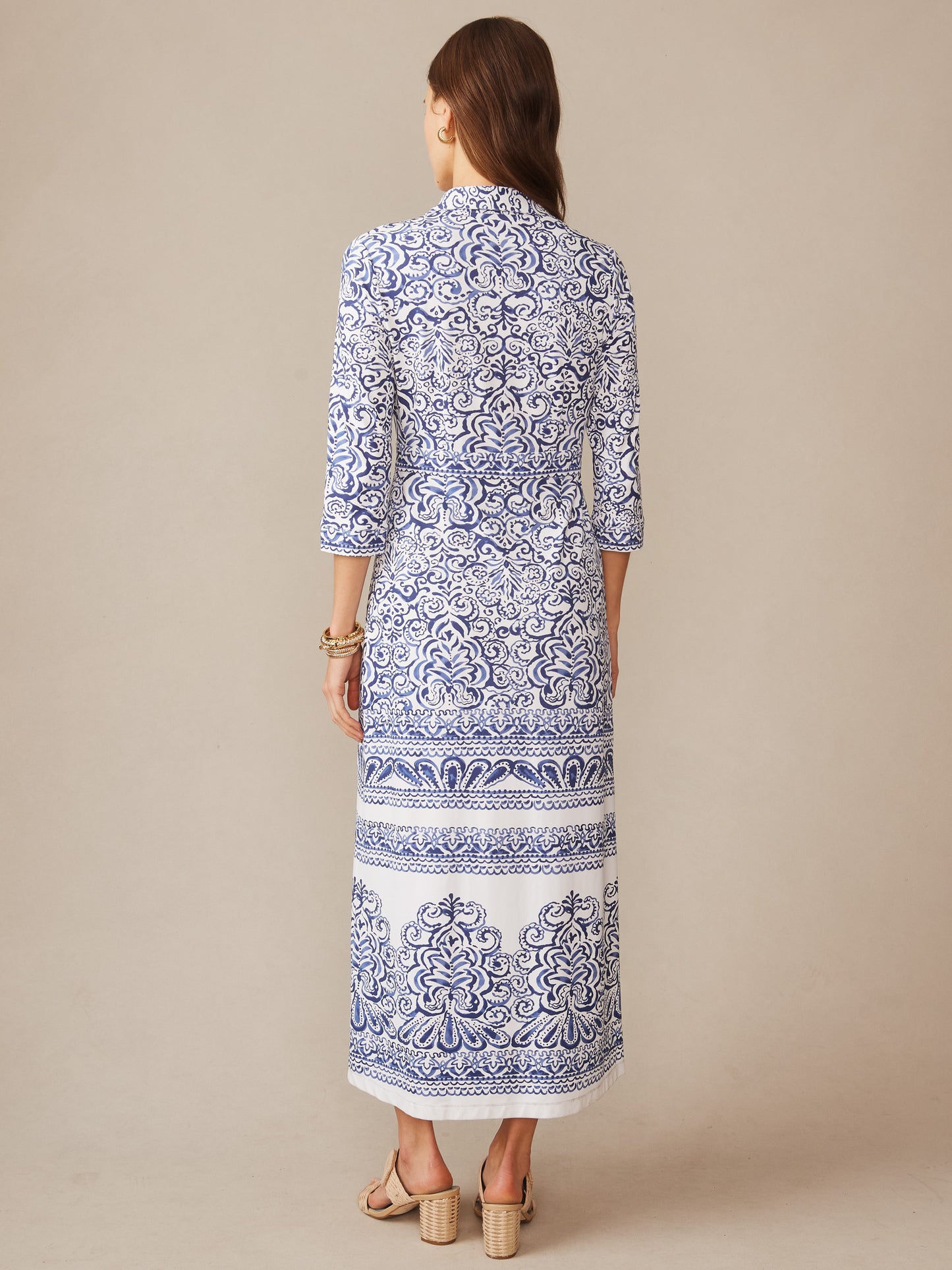 Woman wearing Kailyn Maxi Dress in Faiz Frame by J.McLaughlin, featuring intricate blue and white patterns, embodying effortlessly stylish, enduring designs with innovative fabrics.