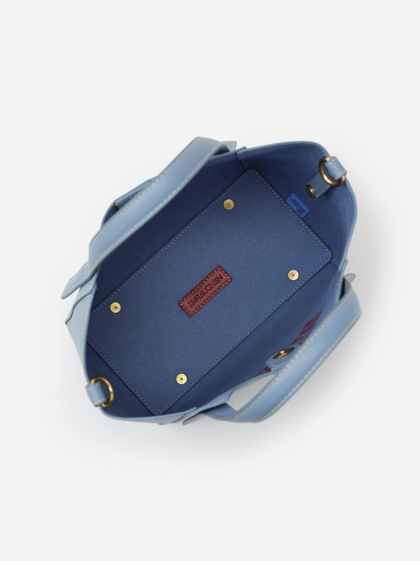 Interior view of the Lane Leather Mini Tote by J.McLaughlin in dusty blue, showcasing impeccable craftsmanship and enduring design in a timeless, effortlessly stylish bag.