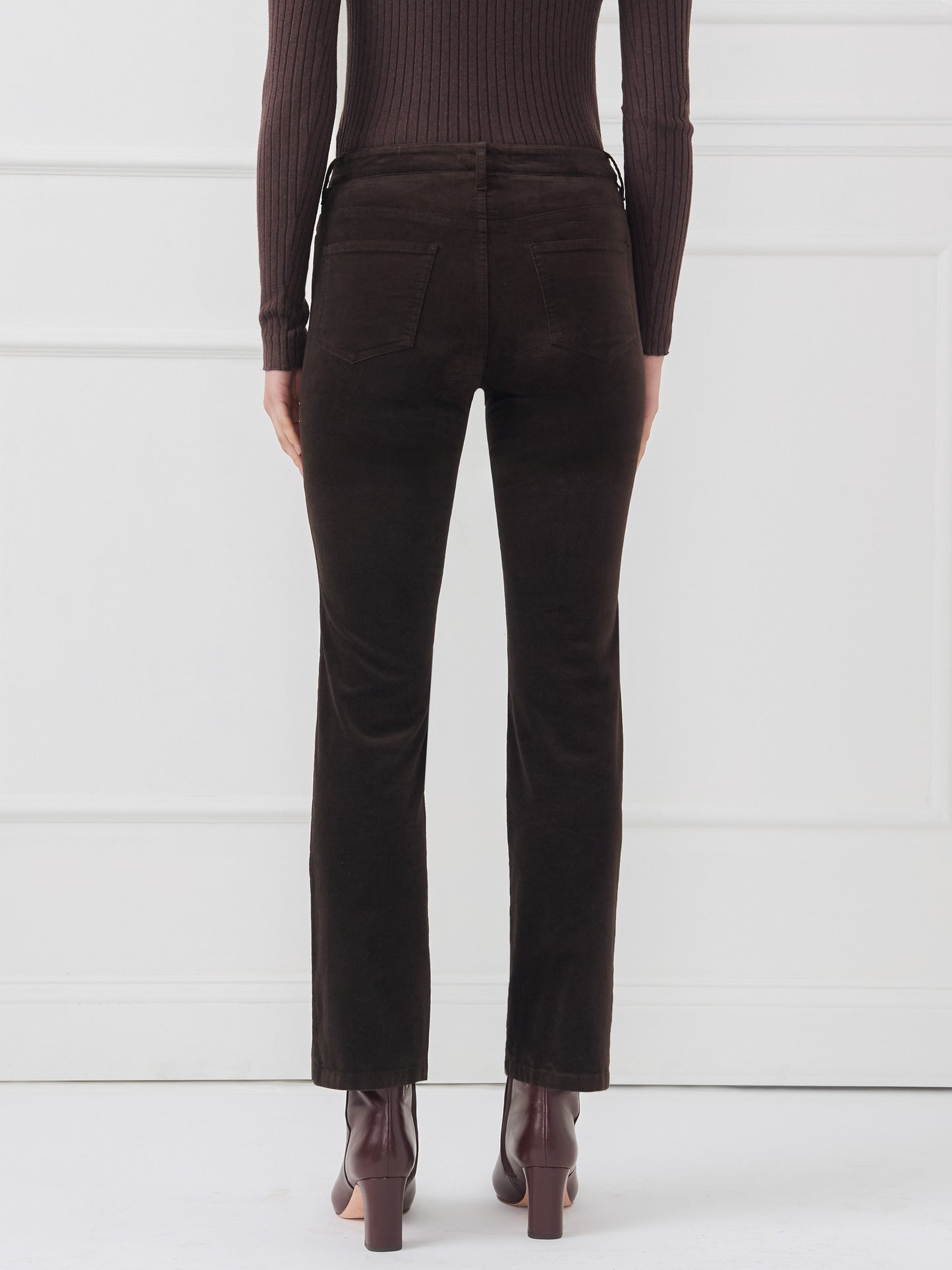 Model wearing J.McLaughlin Lenni pants in dark chocolate made with velveteen.