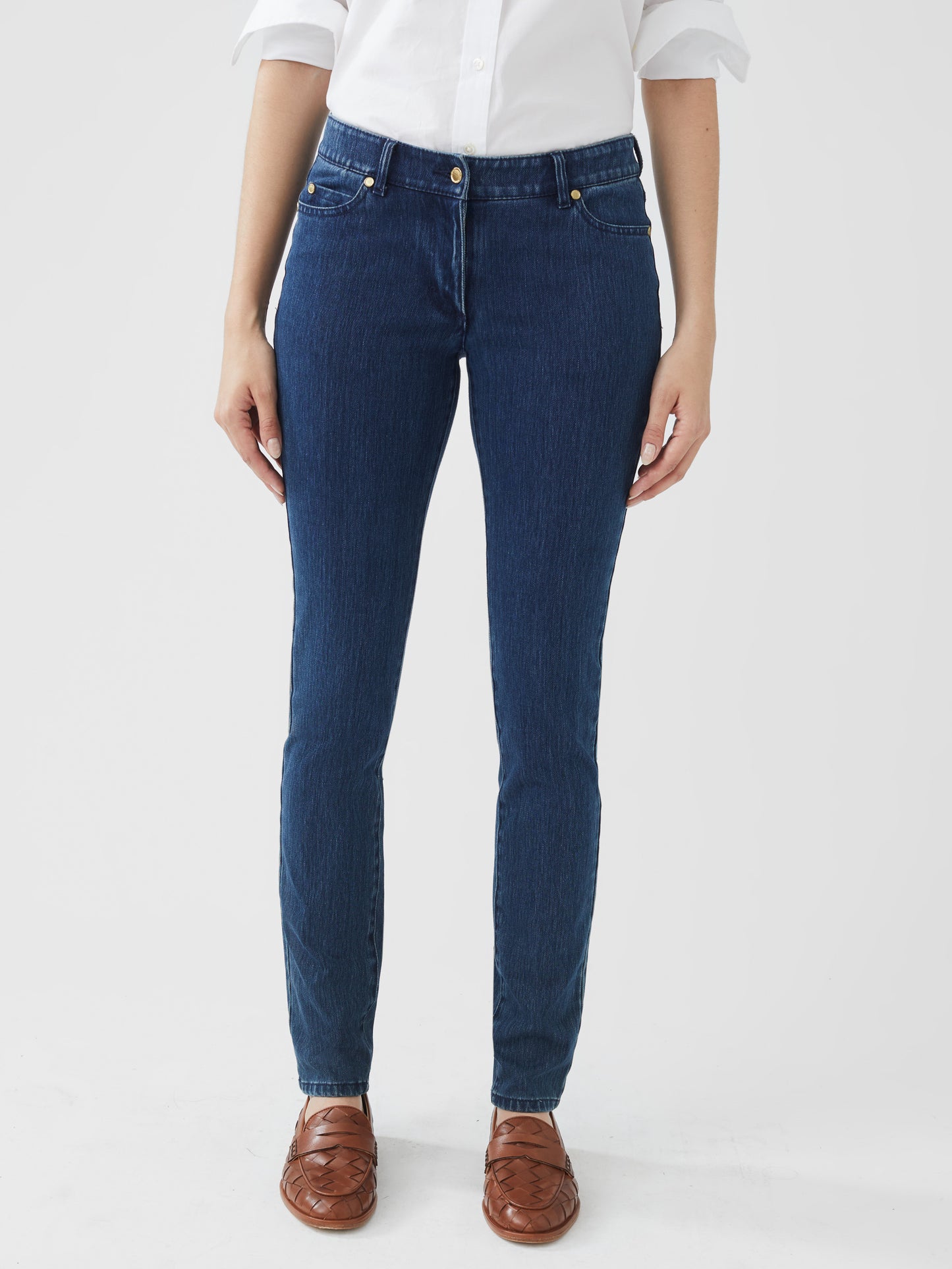 Model wearing J.McLaughlin Lexi jeans in dark denim made with woven denim (cotton).