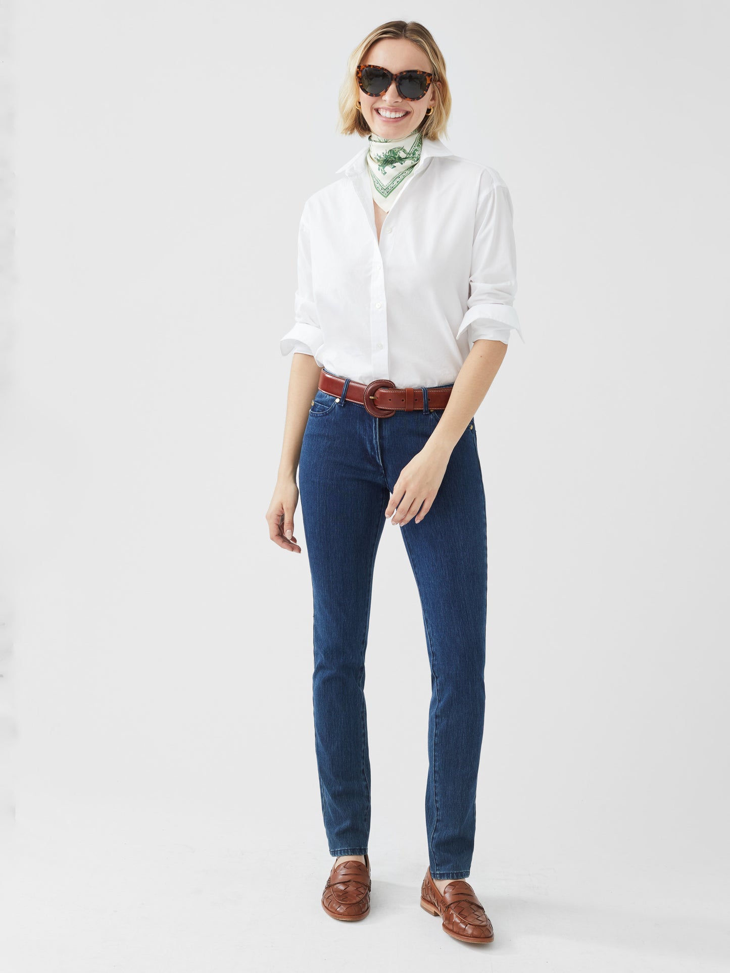 Model wearing J.McLaughlin Lexi jeans in dark denim made with woven denim (cotton).