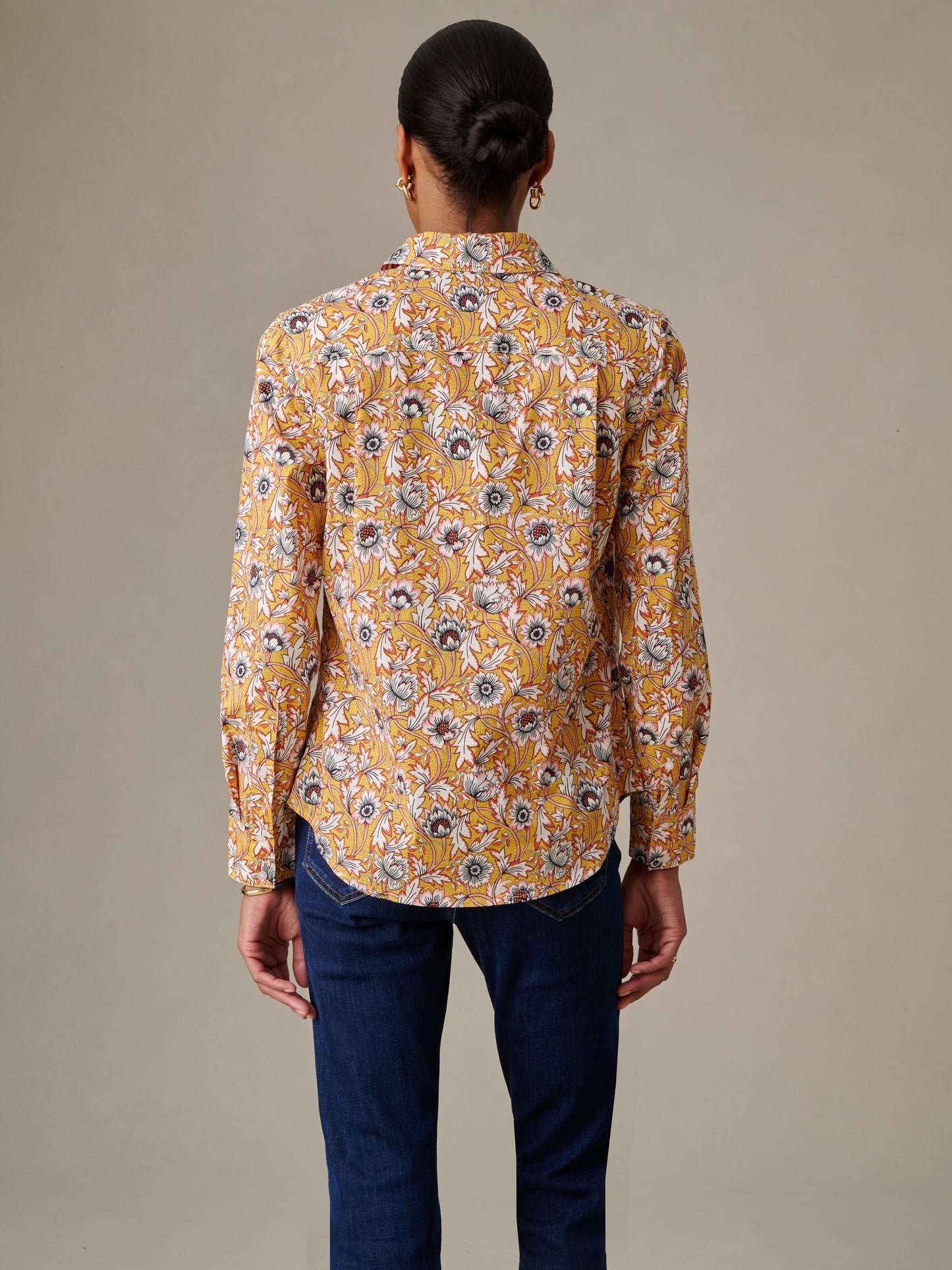 Back view of a person wearing the Lois Shirt in Belle Epoque Bloom Stripe by J.McLaughlin, featuring an effortlessly stylish floral pattern with enduring design quality.