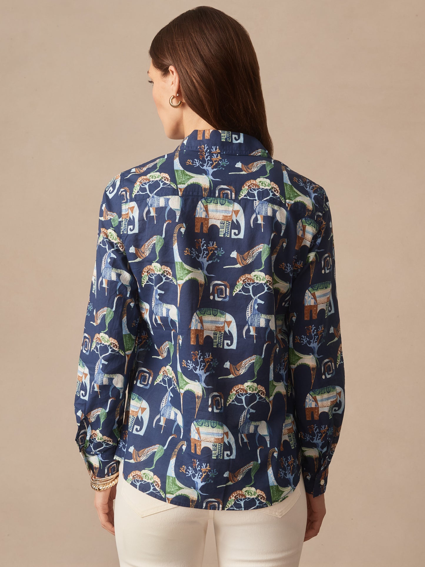 Woman wearing the Lois Shirt in The Wild Stripe by J.McLaughlin, showcasing an effortlessly stylish, enduring design with a playful animal and nature print, embodying a legacy of timeless fashion. A destination for defining style. Life, Well-Lived.