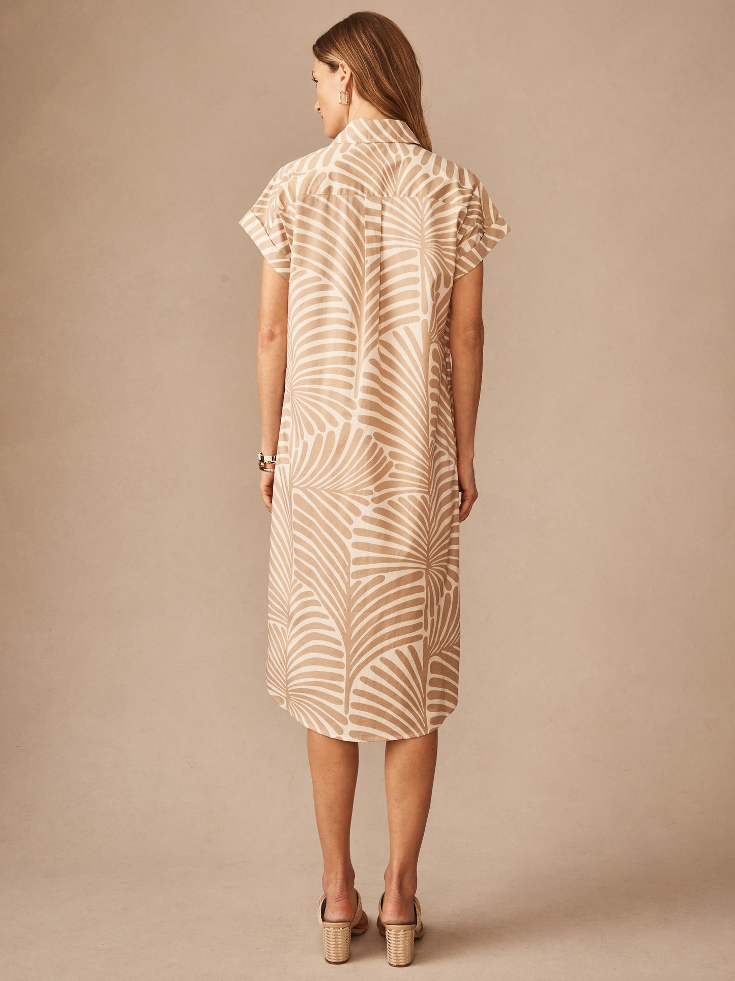 Woman wearing a Luciana Dress in Mod Frond by J.McLaughlin, featuring a tan and off-white leaf pattern with short sleeves, embodying effortlessly stylish, enduring designs in innovative fabrics.