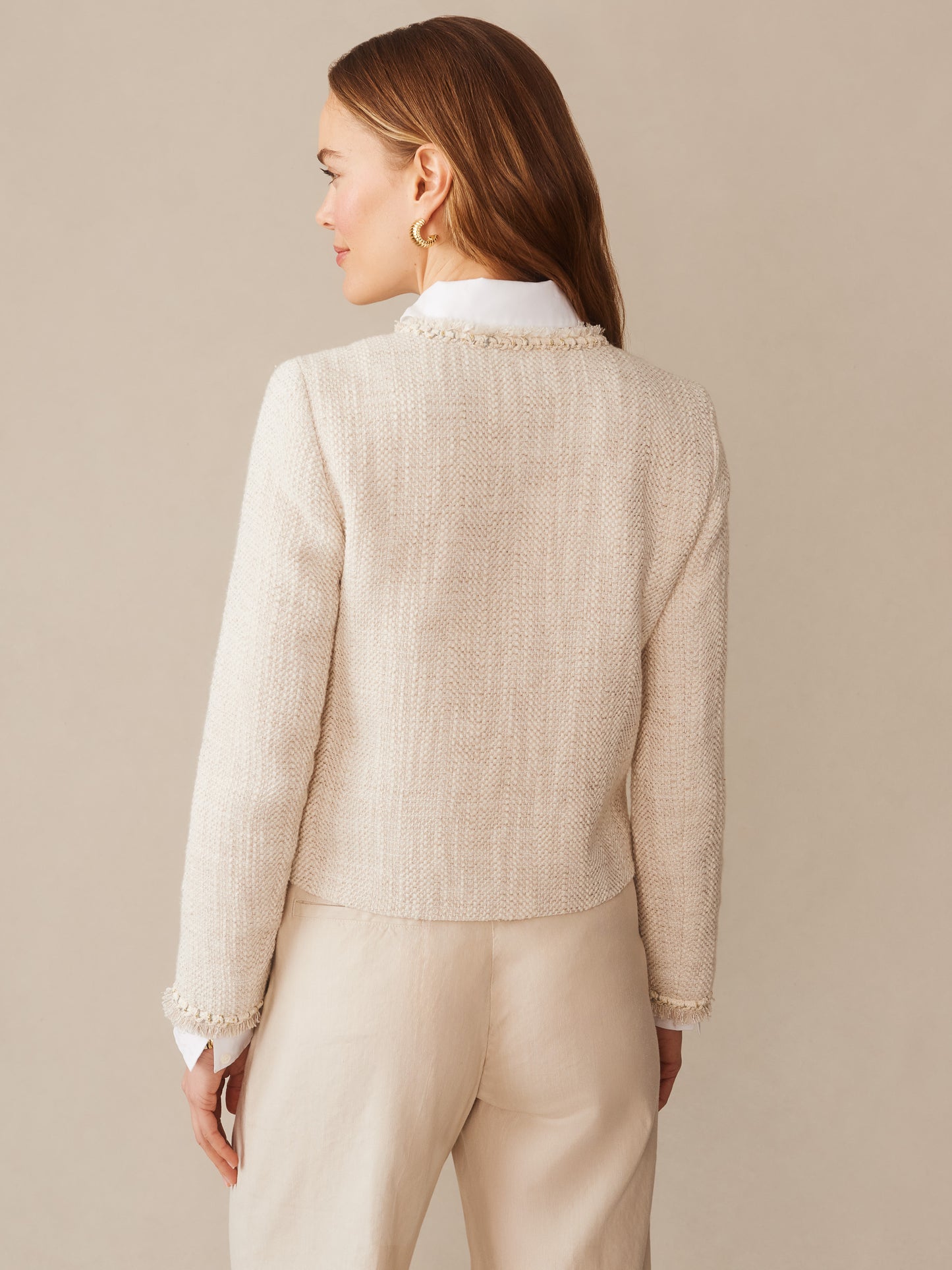 Woman wearing a cream textured Martha Bouclé Jacket by J.McLaughlin, featuring a classic, timeless design with subtle fringe details, embodying effortlessly stylish, enduring designs and innovative fabrics.