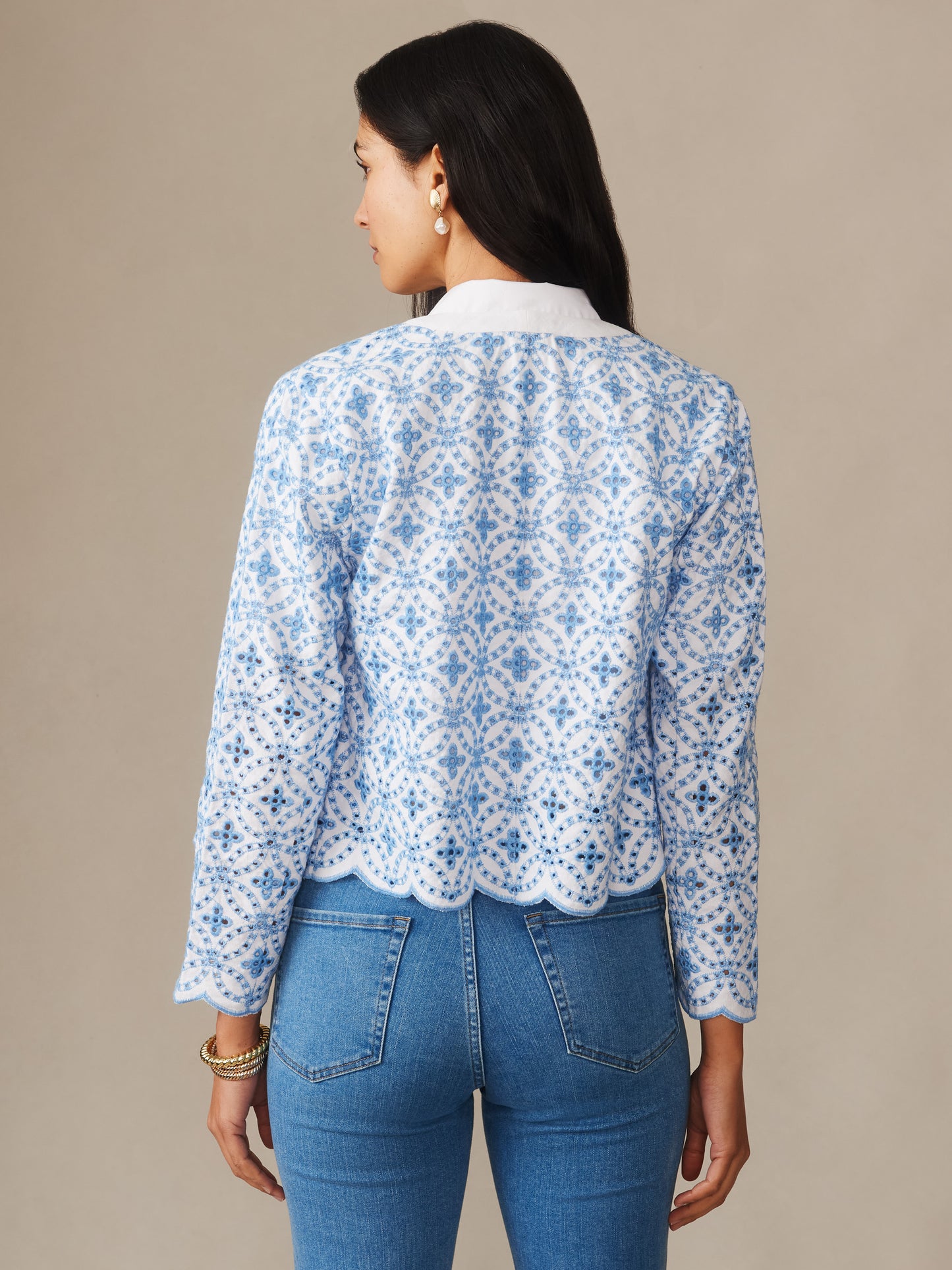 A woman wearing the Martha Linen Blend Eyelet Jacket from J.McLaughlin, featuring delicate sky blue eyelet embroidery with scalloped edges, showcasing effortlessly stylish, enduring designs and innovative fabrics. A destination for defining style. Life, Well-Lived.