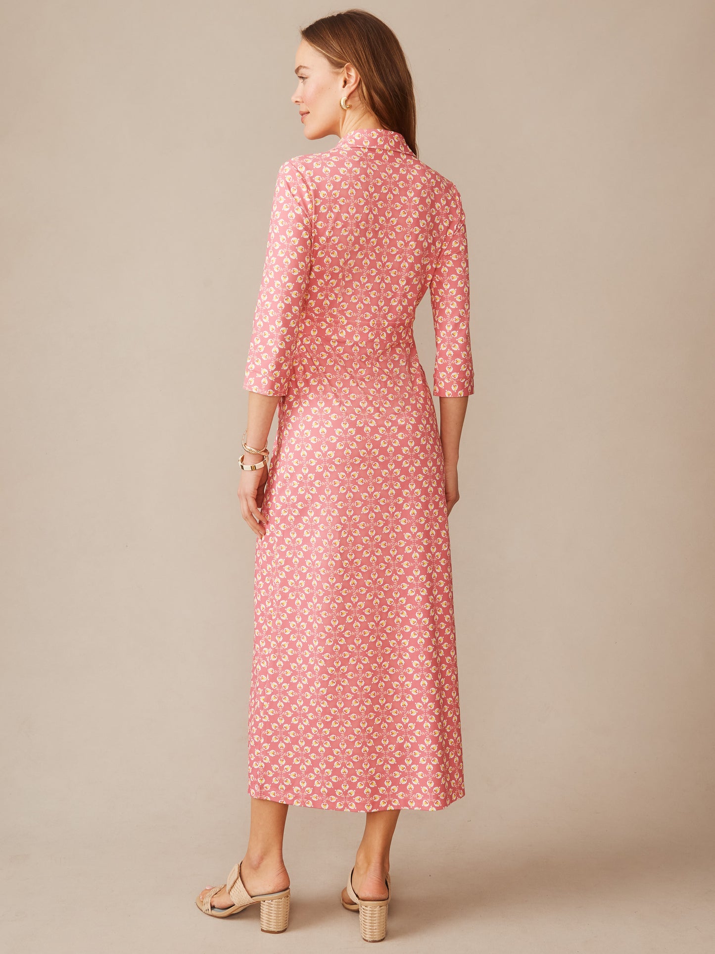 Woman wearing a pink patterned Kailyn Maxi Dress in Mythic Floral Geo by J.McLaughlin, showcasing effortlessly stylish, enduring designs with a classic silhouette, a destination for defining style. Life, Well-Lived.