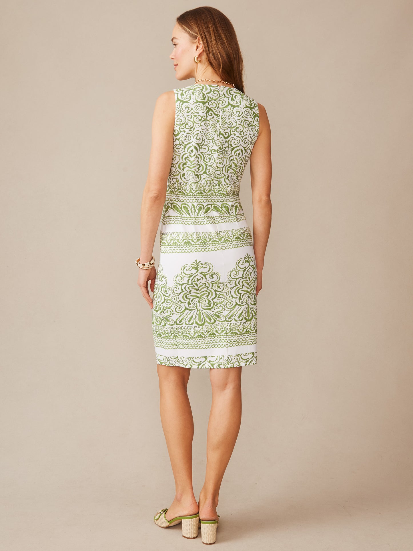 Woman modeling the Sophia Sleeveless Dress in Faiz Engineer by J.McLaughlin, showcasing a green and white patterned design that embodies effortlessly stylish, enduring designs and a legacy of timeless fashion at a destination for defining style. Life, Well-Lived.