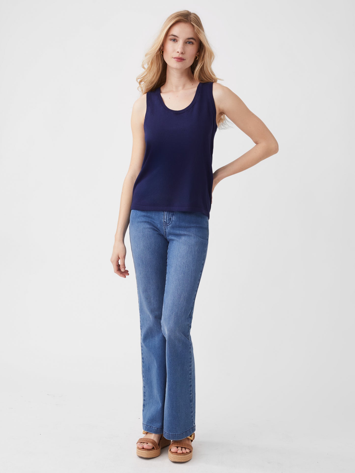 Model wearing J.McLaughlin Maybelle sweater tank in navy made with cotton/viscose/nylon/cashmere.