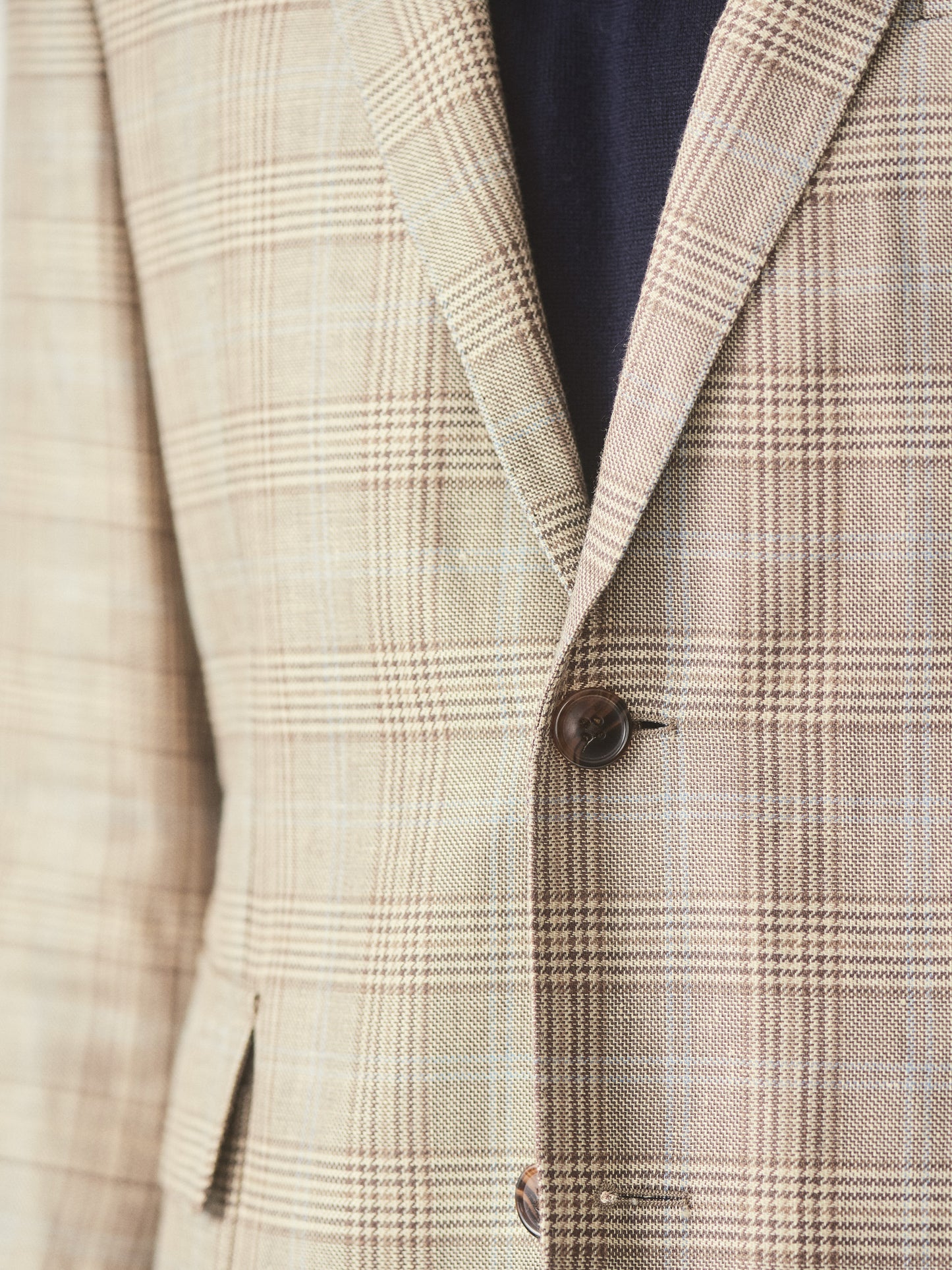Model wearing J.McLaughlin McCown blazer in tan/brown/blue made with wool and linen.