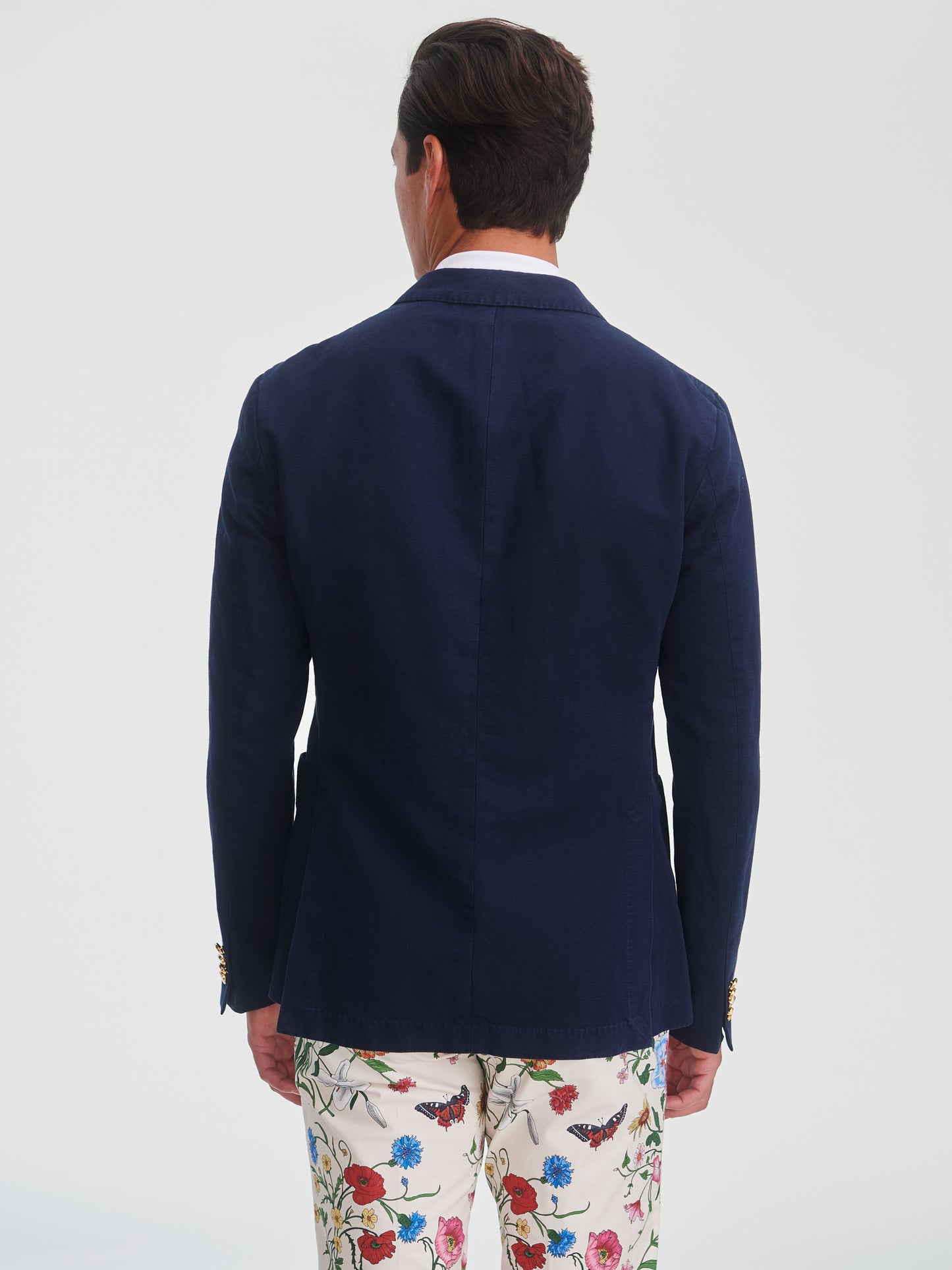 Man wearing a navy Mark Sport Coat by J.McLaughlin, showcasing effortlessly stylish, enduring designs with innovative fabrics in a legacy of timeless fashion. A destination for defining style. Life, Well-Lived.