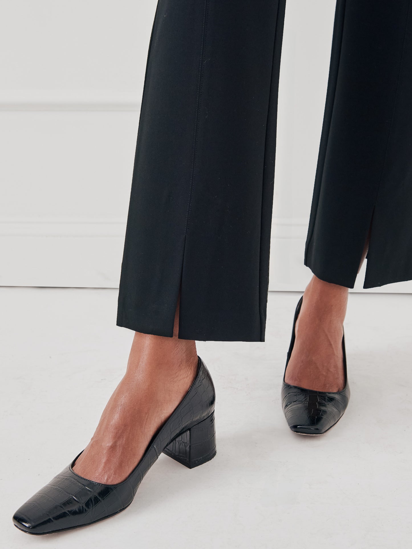 Model wearing J.McLaughlin Deanne pants in black made with Bainbridge fabric.