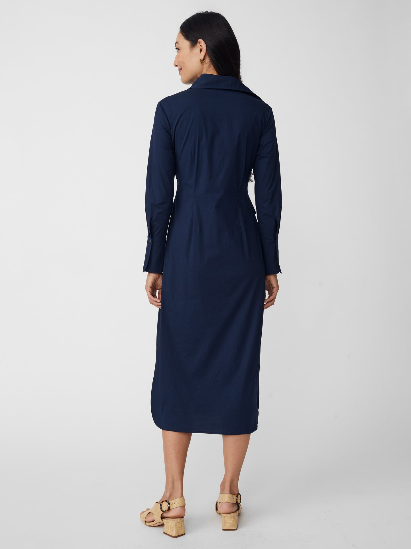 Model wearing J.McLaughlin Orla dress in navy made with cotton/nylon/elastane.