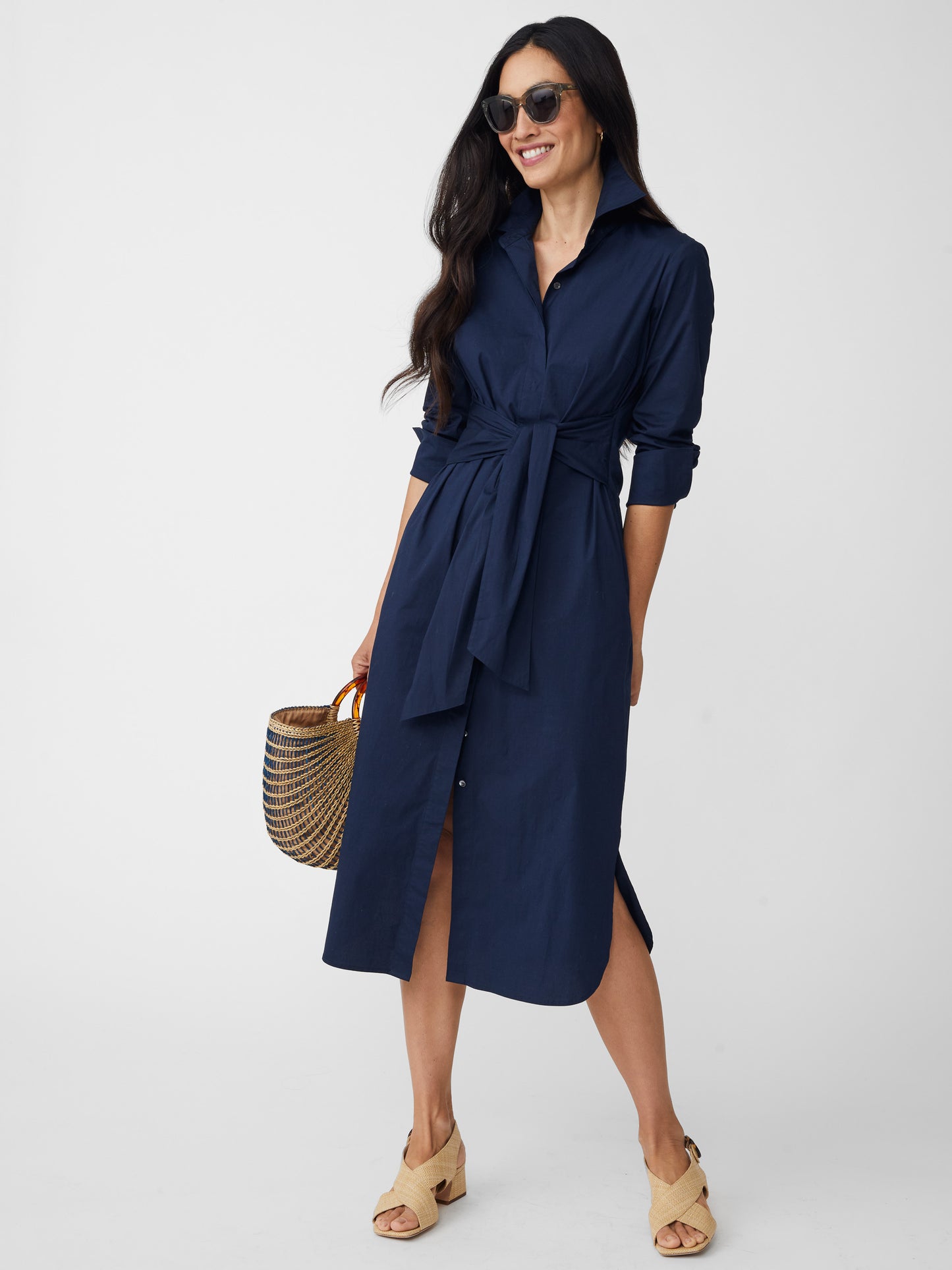 Model wearing J.McLaughlin Orla dress in navy made with cotton/nylon/elastane.