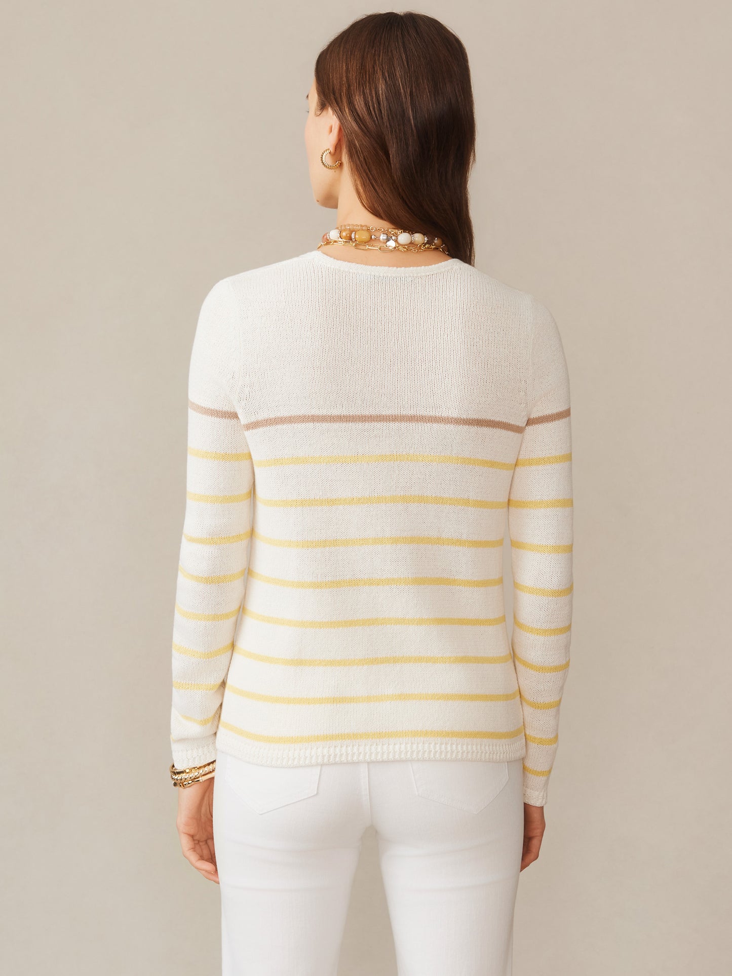 Back view of a woman wearing the Ramona Linen Blend Sweater in Stripe by J.McLaughlin, featuring soft yellow and neutral stripes, showcasing effortlessly stylish, enduring designs with innovative fabrics, reflecting a legacy of timeless fashion. A destination for defining style. Life, Well-Lived.