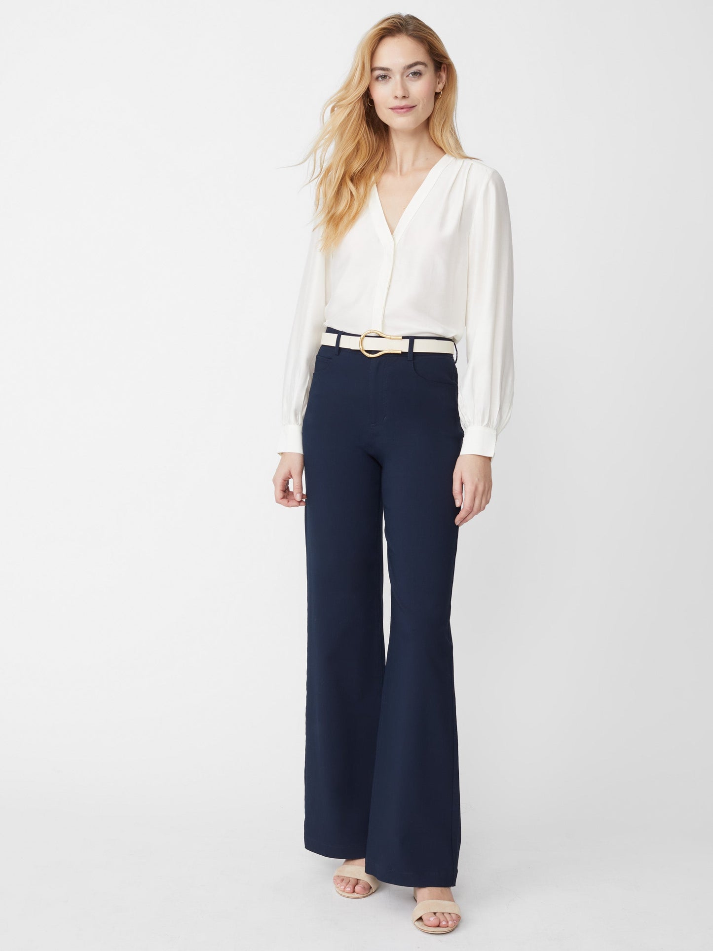 Model wears J.McLaughlin Rinaldo blouse in off white made with silk/rayon.