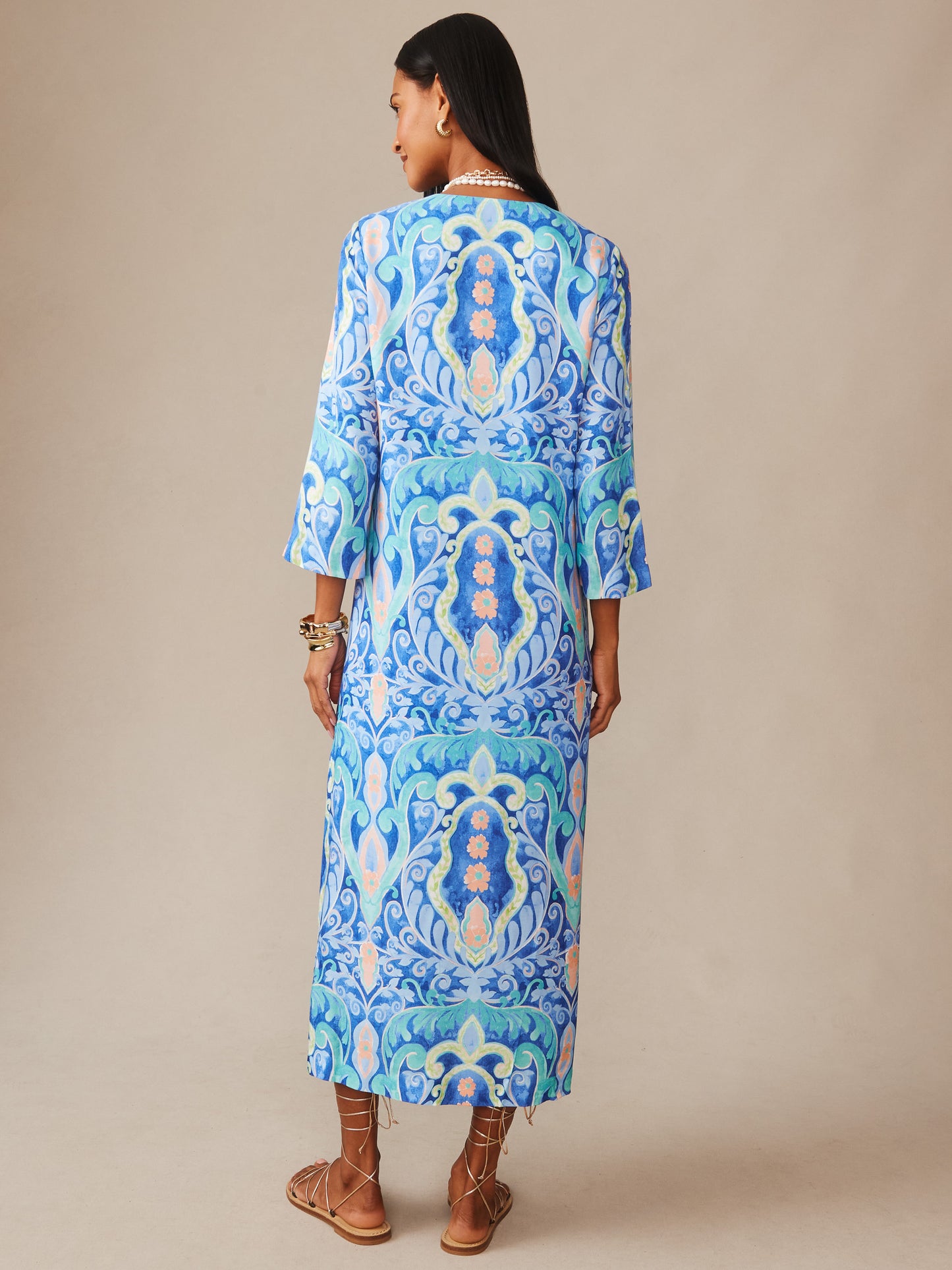 Woman wearing a Roni Silk Blend Dress in Midi Deco Bloom by J.McLaughlin, featuring a vibrant blue and aqua patterned design, embodying effortlessly stylish and enduring designs, a destination for defining style. Life, Well-Lived.