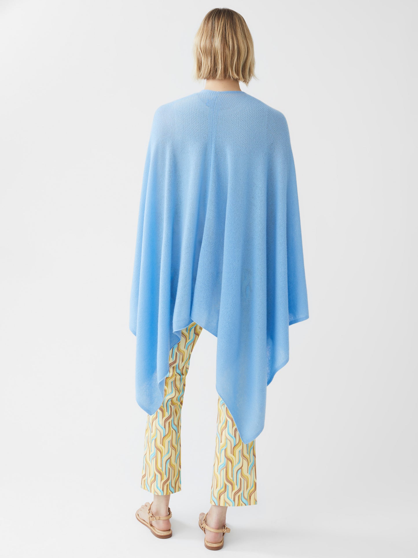 Model wearing J.McLaughlin Rossi wrap in light blue made with cashmere.