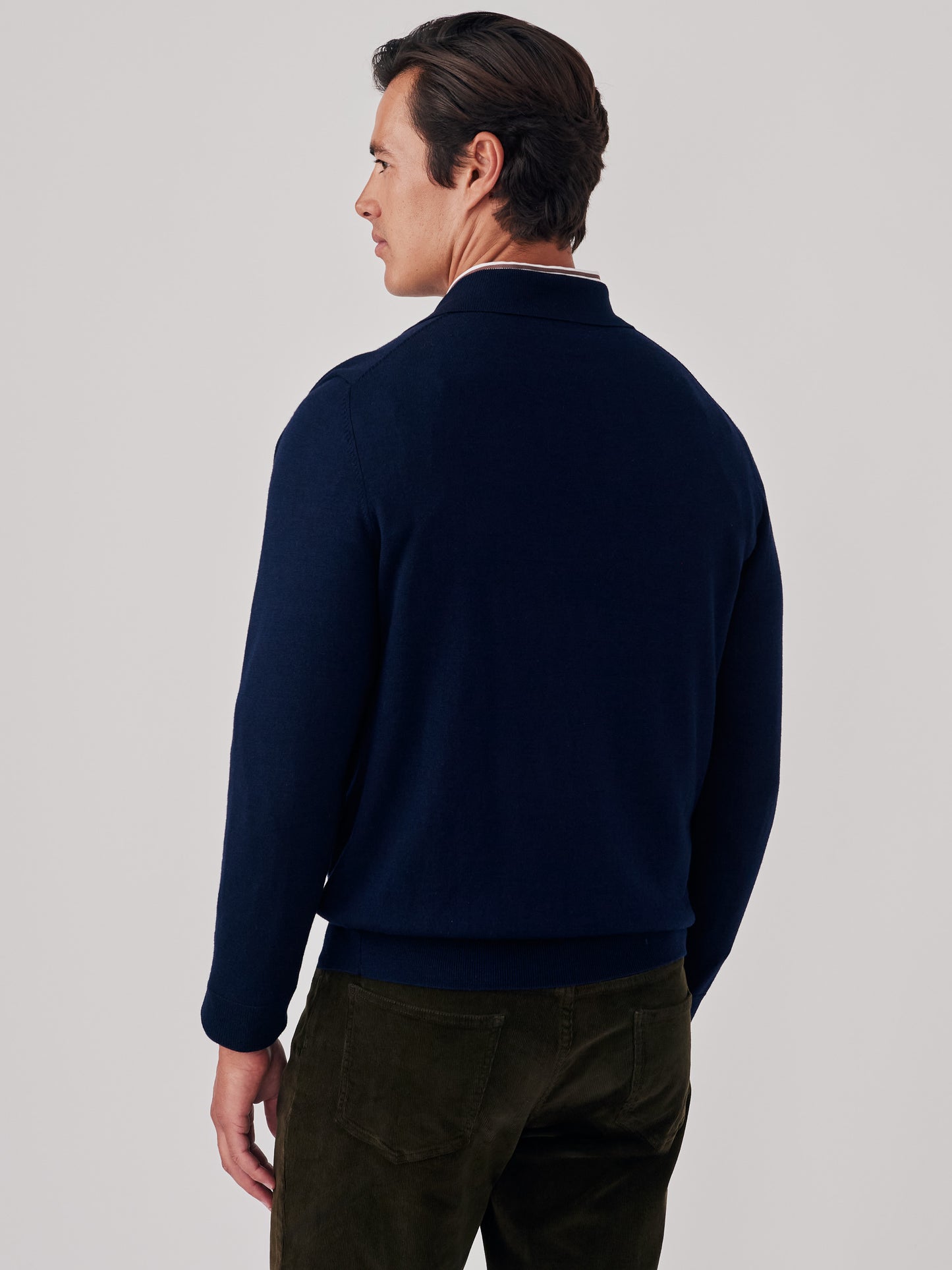 Model wearing J.McLaughlin Savona sweater in dark navy made with wool and silk.