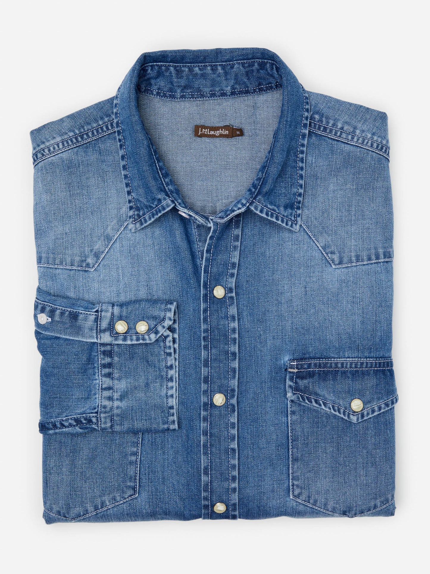 Model wearing J.McLaughlin Ace shirt in light denim made with cotton.