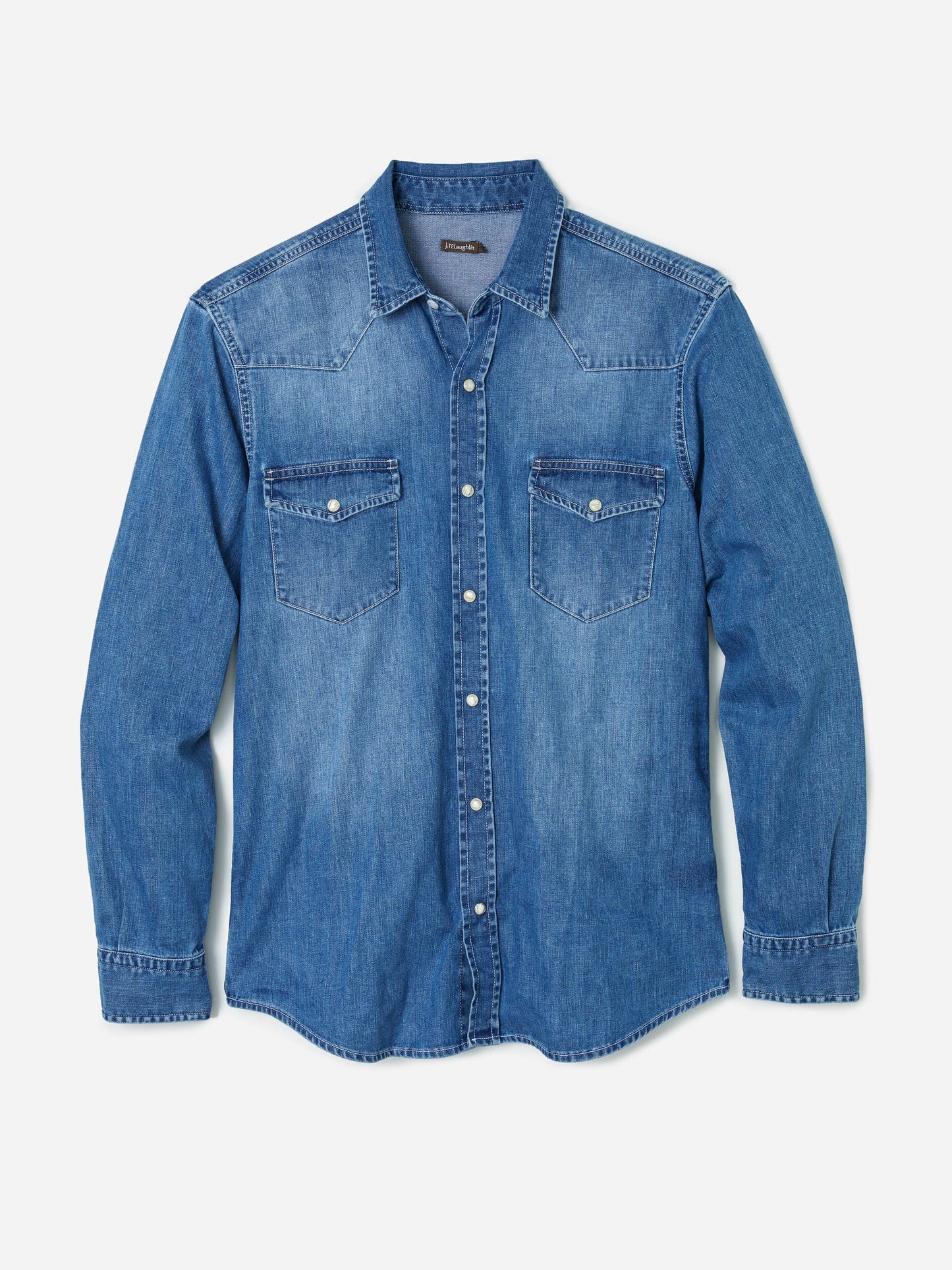 Model wearing J.McLaughlin Ace shirt in light denim made with cotton.