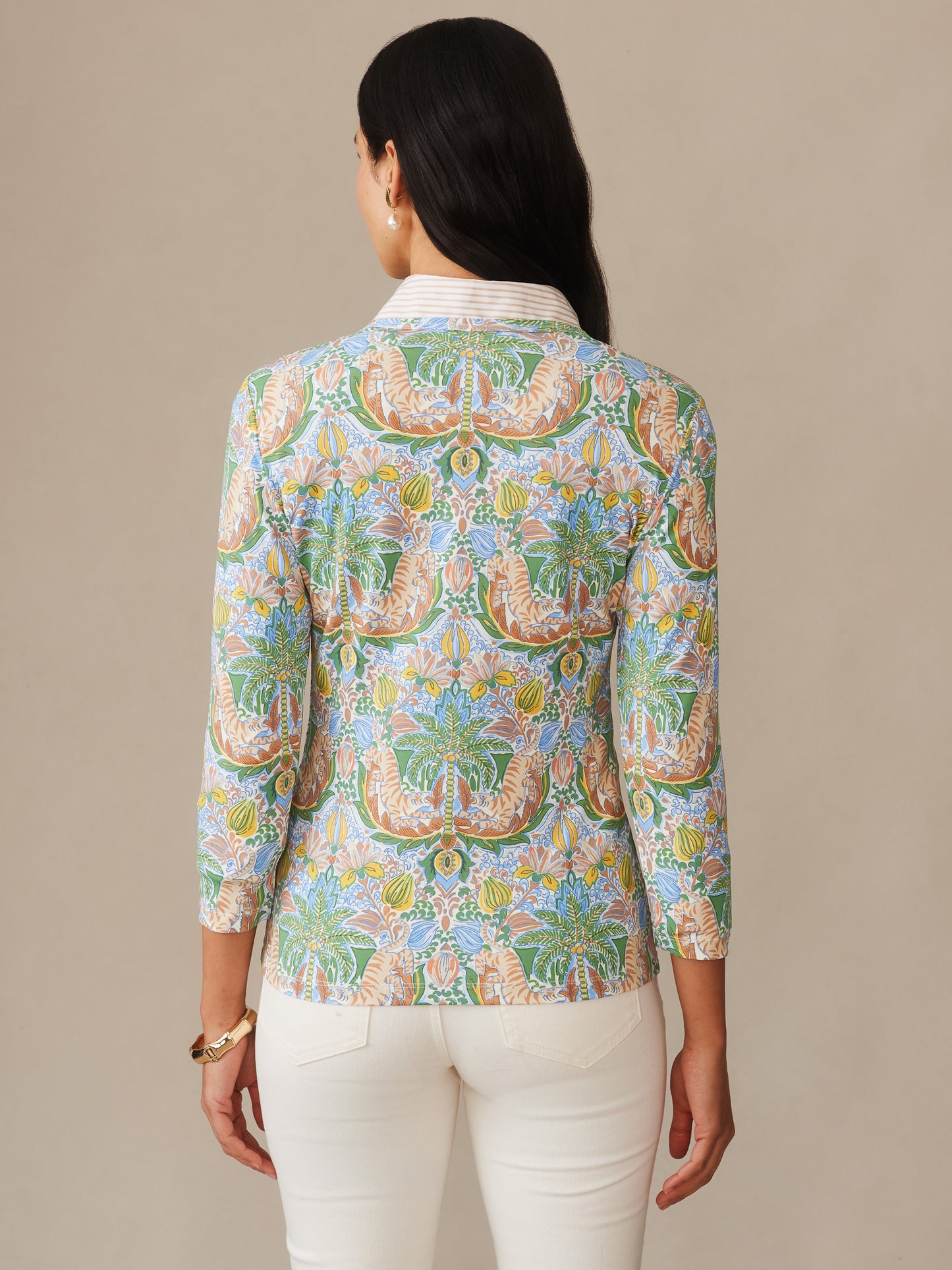 Woman wearing J.McLaughlin Signature Tee in Tigress Tropico featuring an intricate tropical-inspired pattern in green, blue, and brown tones, highlighting effortlessly stylish, enduring designs and innovative fabrics for a legacy of timeless fashion. A destination for defining style. Life, Well-Lived.