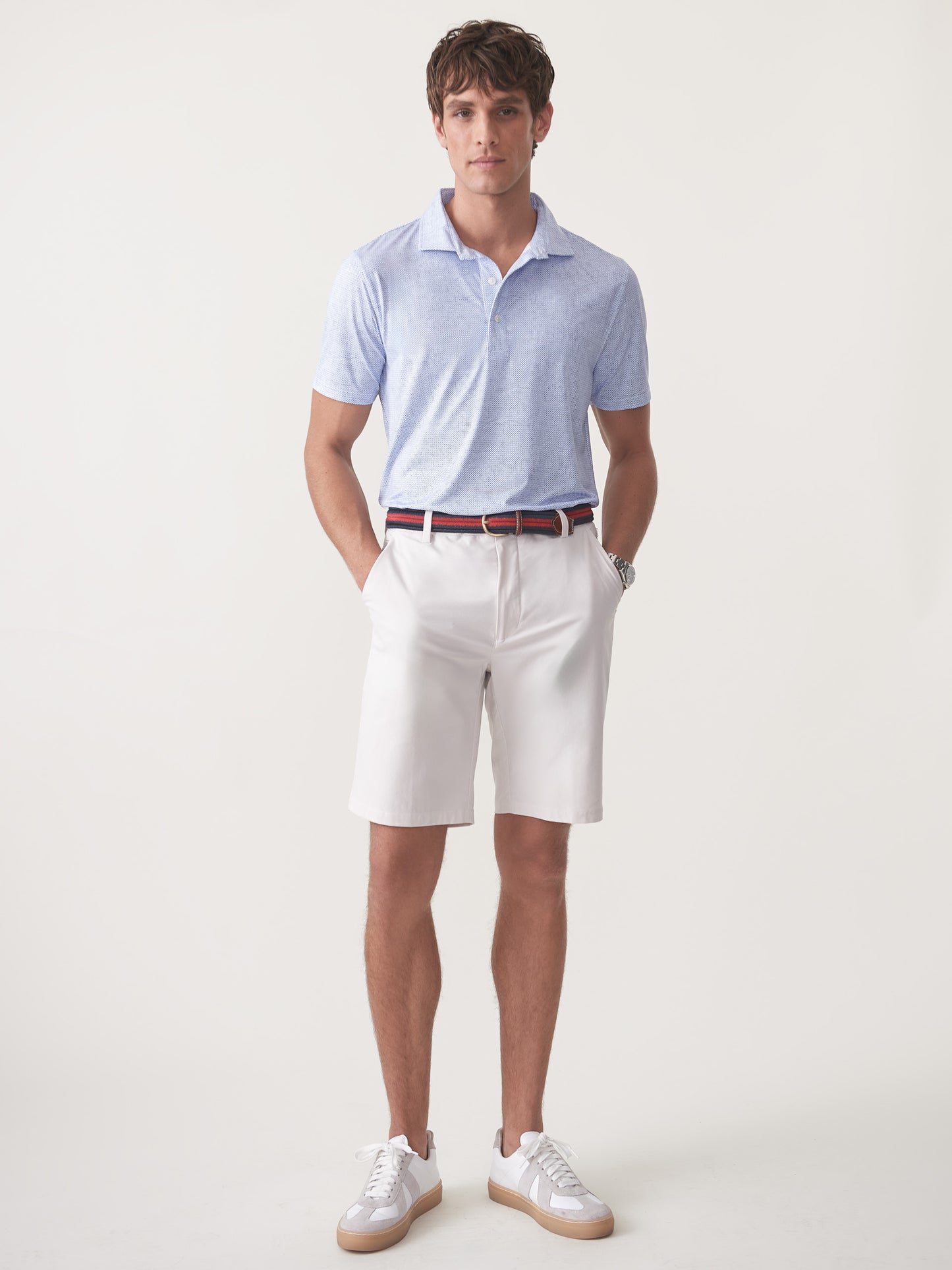 Model wearing J.McLaughlin Silas shorts in stone made with performance fabric.