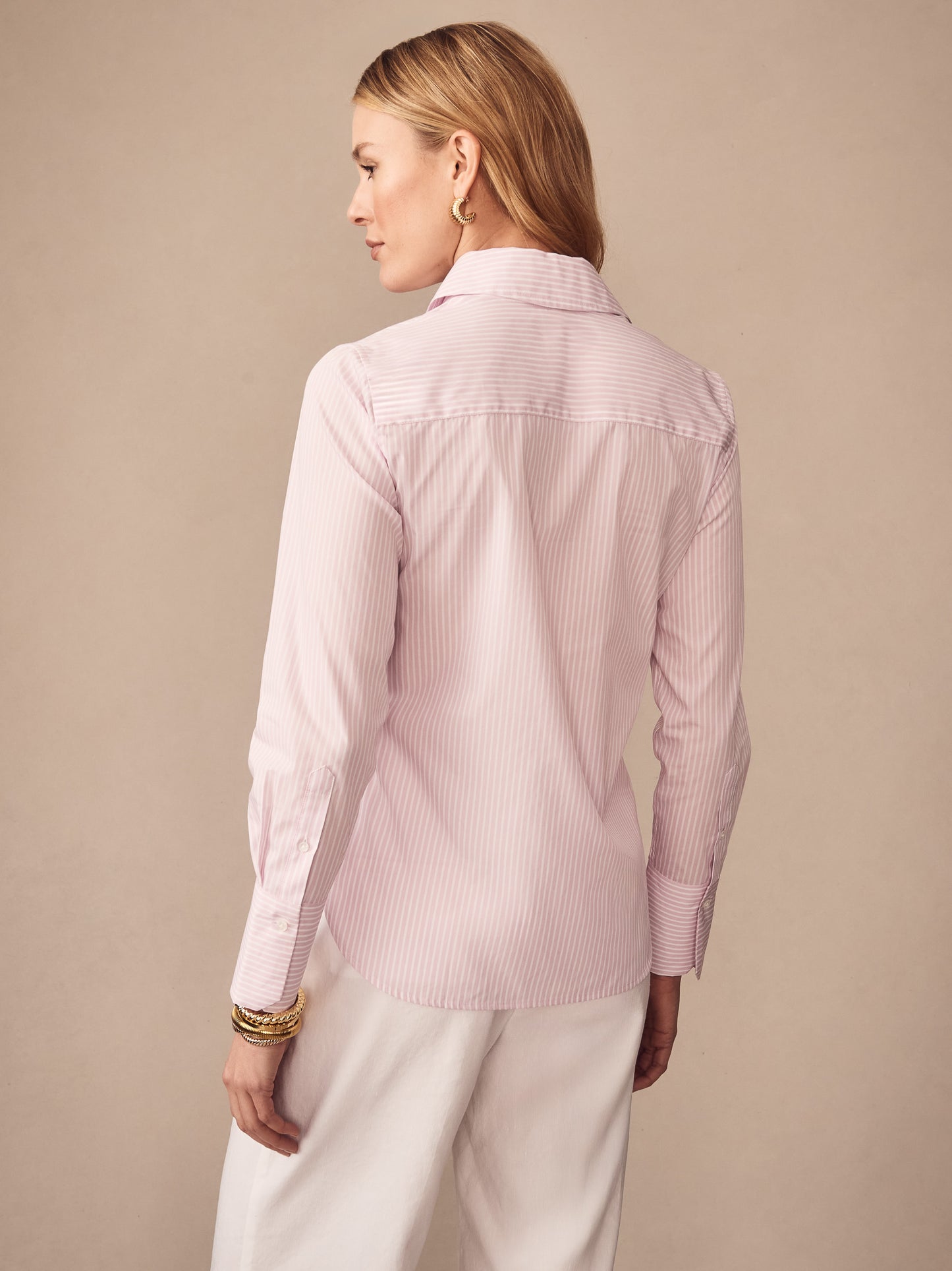 Model wearing the Sloane Shirt in Stripe by J.McLaughlin, showcasing effortlessly stylish design and enduring fabrics as part of a legacy of timeless fashion. A destination for defining style. Life, Well-Lived.