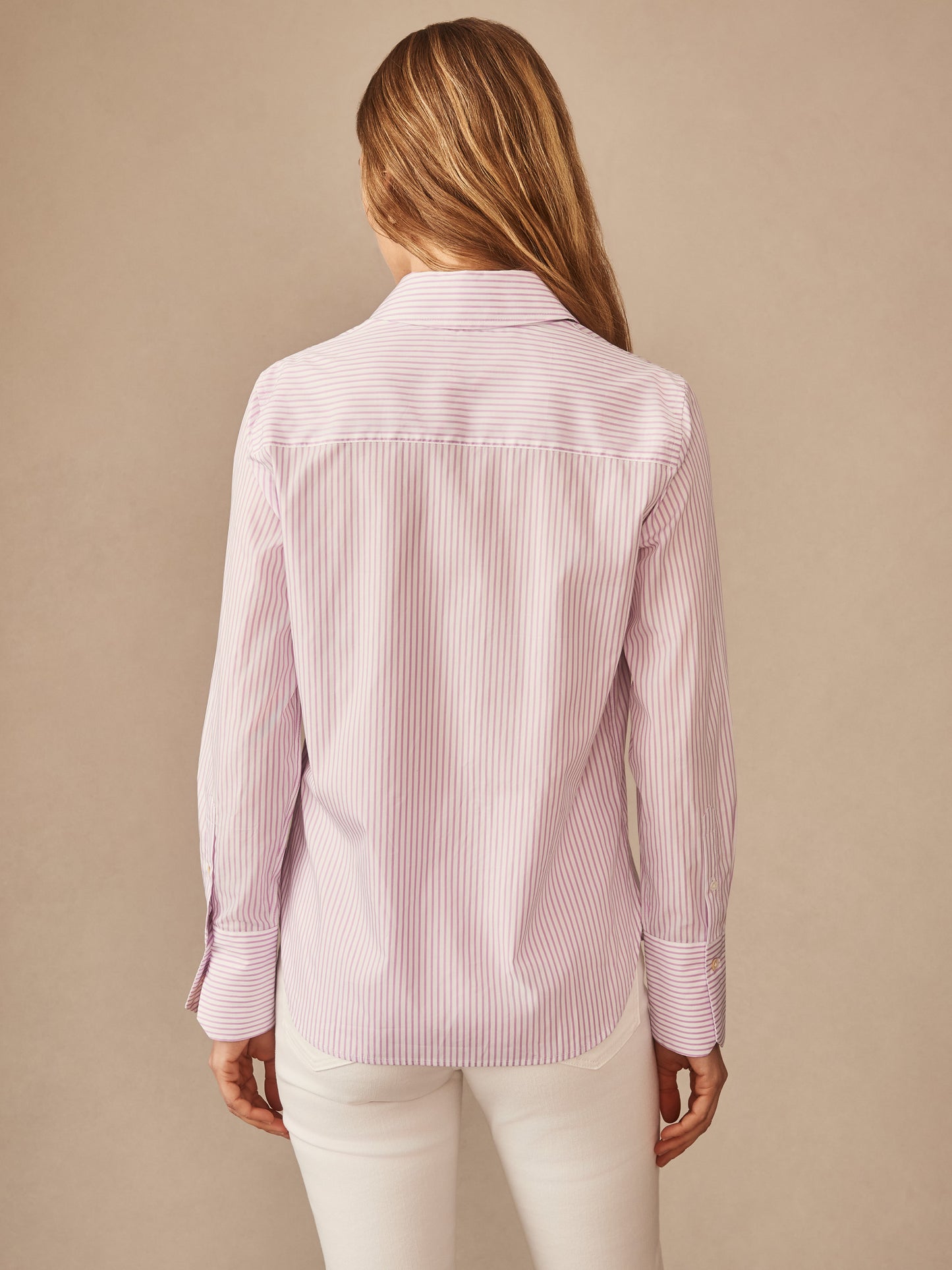 Back view of a woman wearing the Sloane Shirt in Stripe by J.McLaughlin, featuring soft lavender and white stripes in an effortlessly stylish, enduring design, a destination for defining style. Life, Well-Lived.