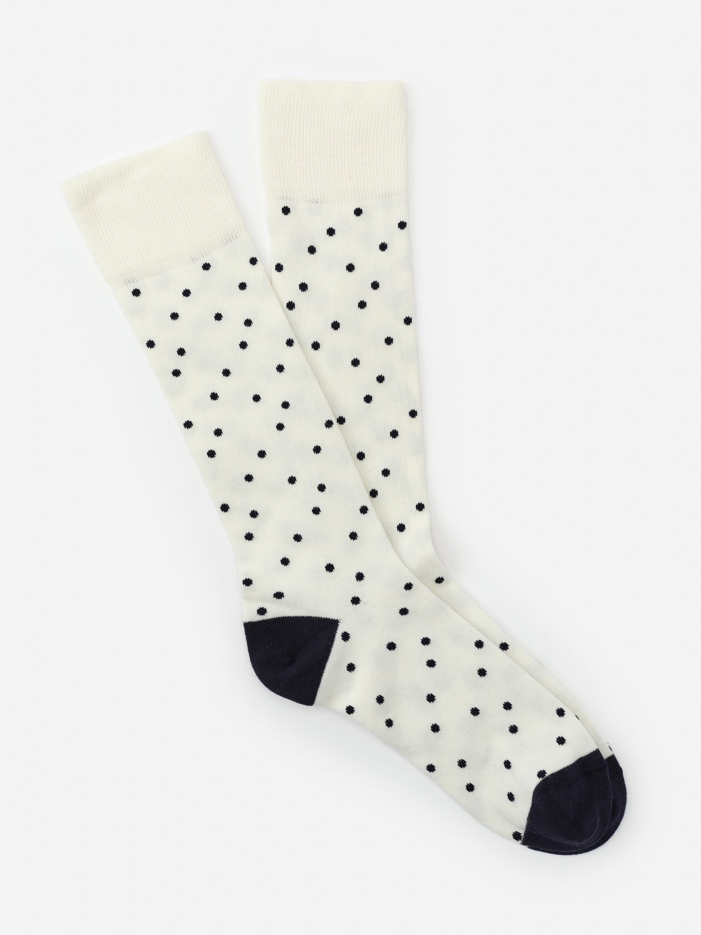 Socks in Polka Dots from J.McLaughlin featuring navy polka dots on a white background with navy heel and toe, combining effortlessly stylish design and enduring fabrics in a classic look.
