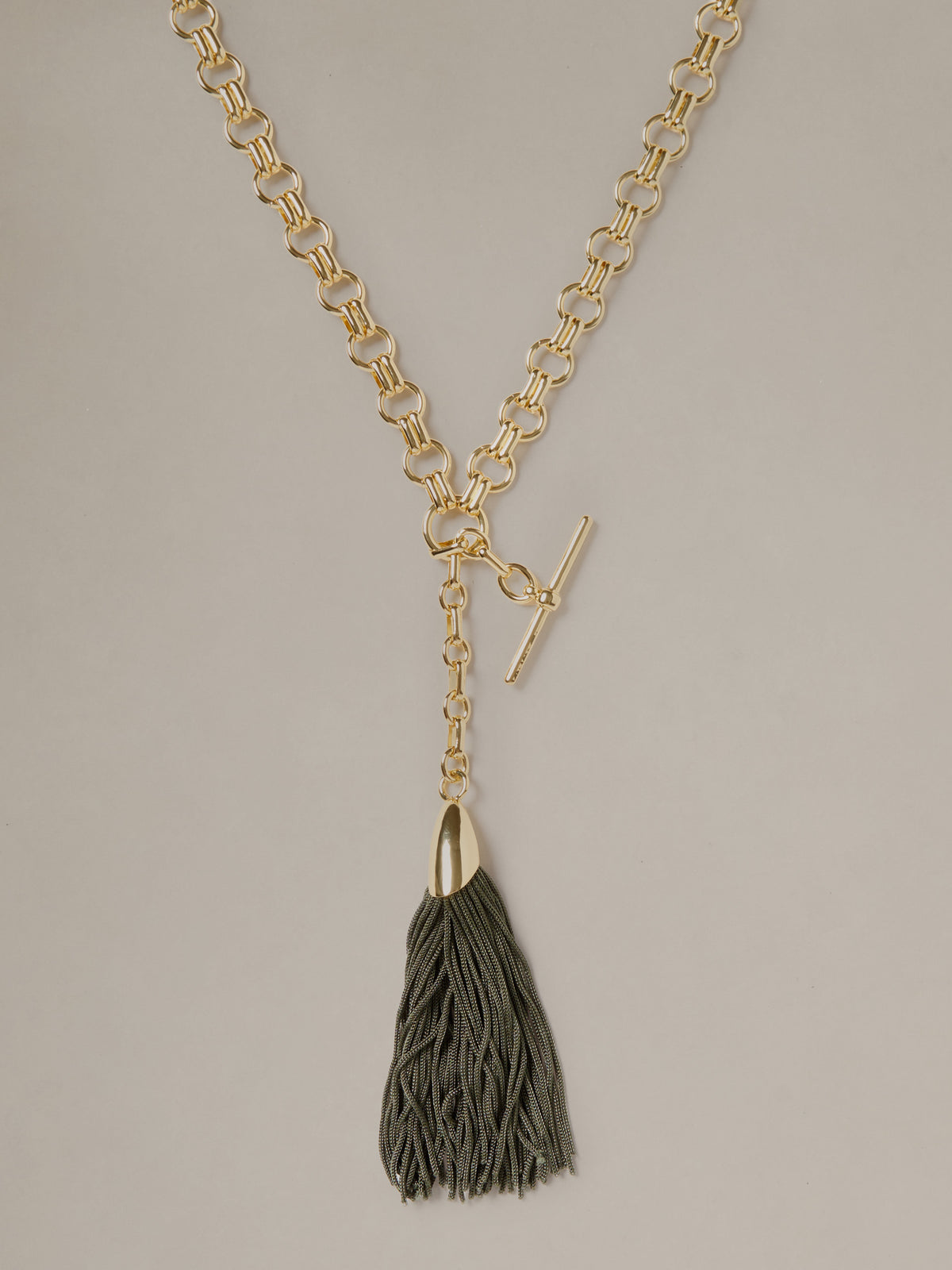 J.McLaughlin Tassel Toggle Necklace with a gold tone chain toggle closure and dark textured tassel for timeless everyday style
