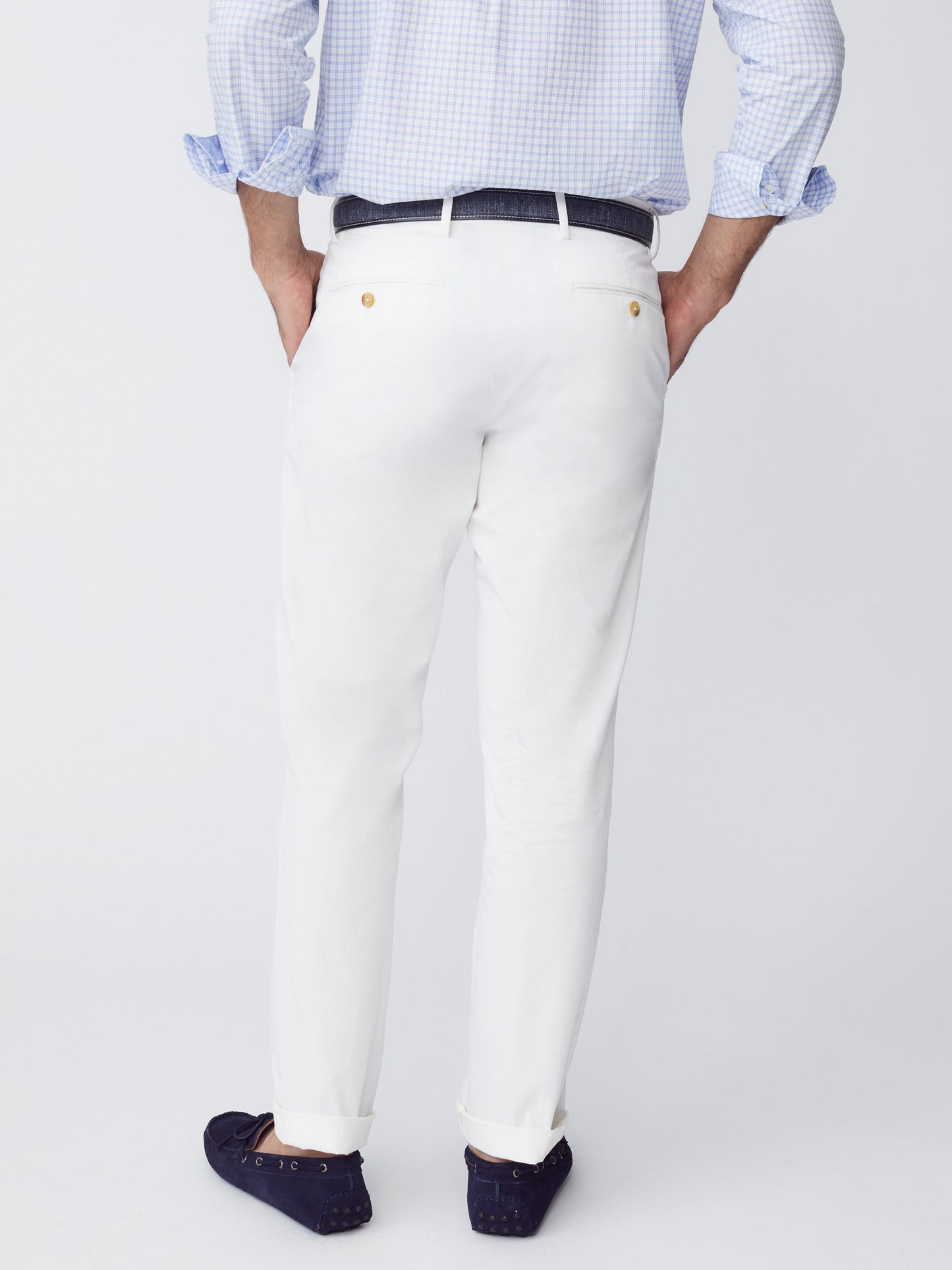 Model wearing J.McLaughlin Taylor pants in white made with cotton/spandex.