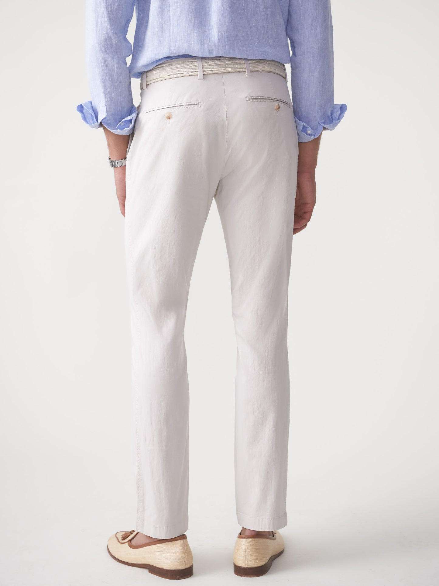 Model wearing J.McLaughlin Taylor pants in stone made with cotton/spandex.