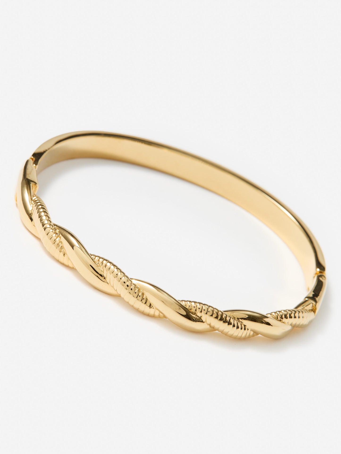 J.McLaughlin twist hinge bangle in gold made with brass.