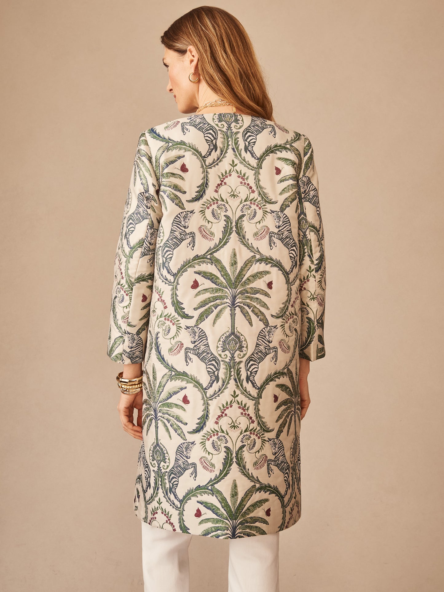 Model wearing the Judy Coat in Maxi Zebra Isle Jacquard by J.McLaughlin, featuring a detailed zebra and botanical pattern on an innovative fabric, embodying effortlessly stylish and enduring designs.