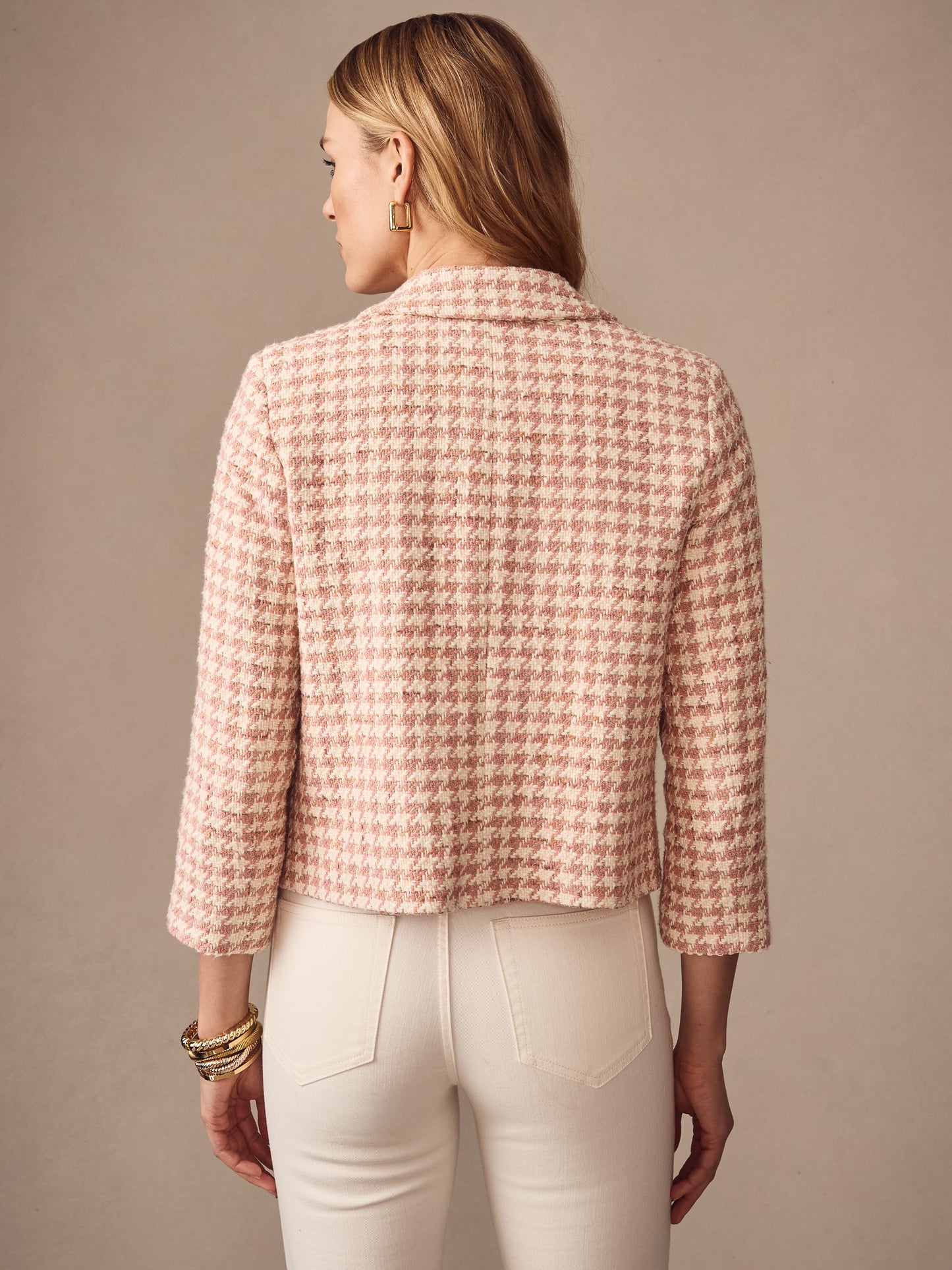 Back view of a woman wearing the Violette Tweed Jacket in Houndstooth by J.McLaughlin, featuring a classic pink and white pattern, effortlessly stylish with enduring designs and innovative fabrics, embodying a legacy of timeless fashion at a destination for defining style. Life, Well-Lived.