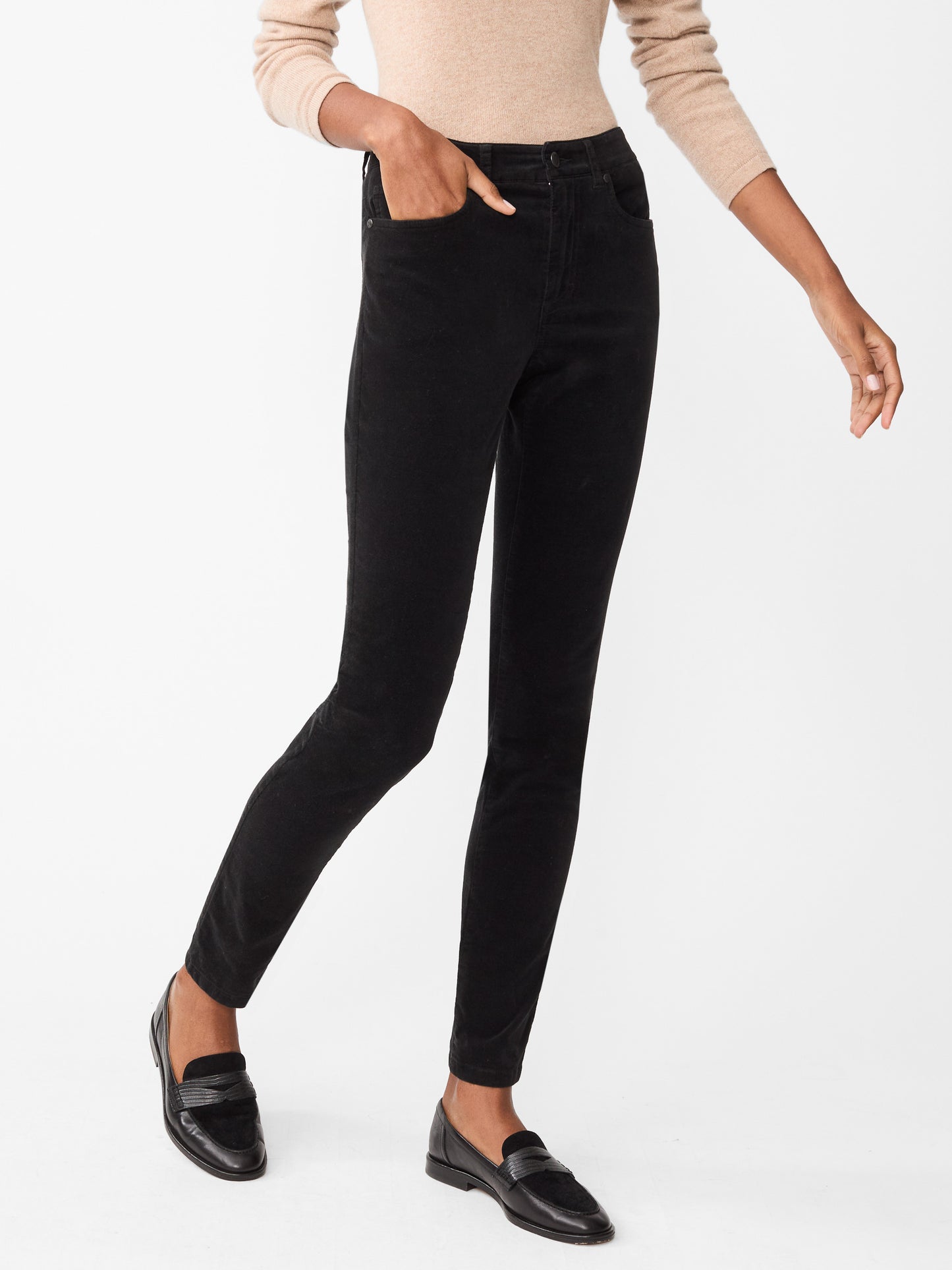 Model wearing J.McLaughlin Watson jeans in black made with velveteen.