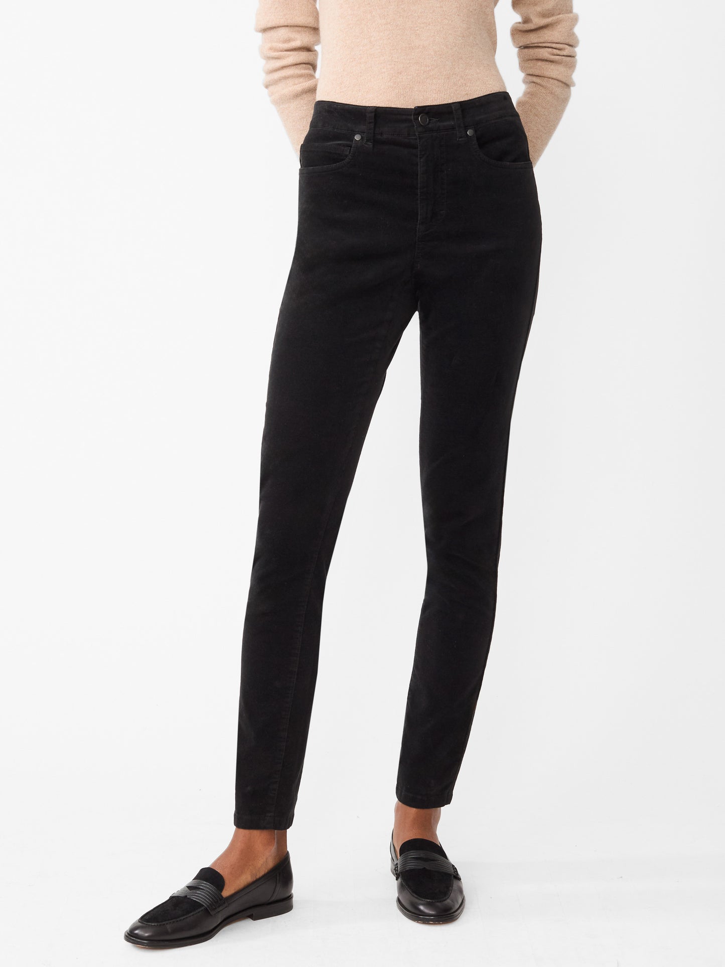 Model wearing J.McLaughlin Watson jeans in black made with velveteen.