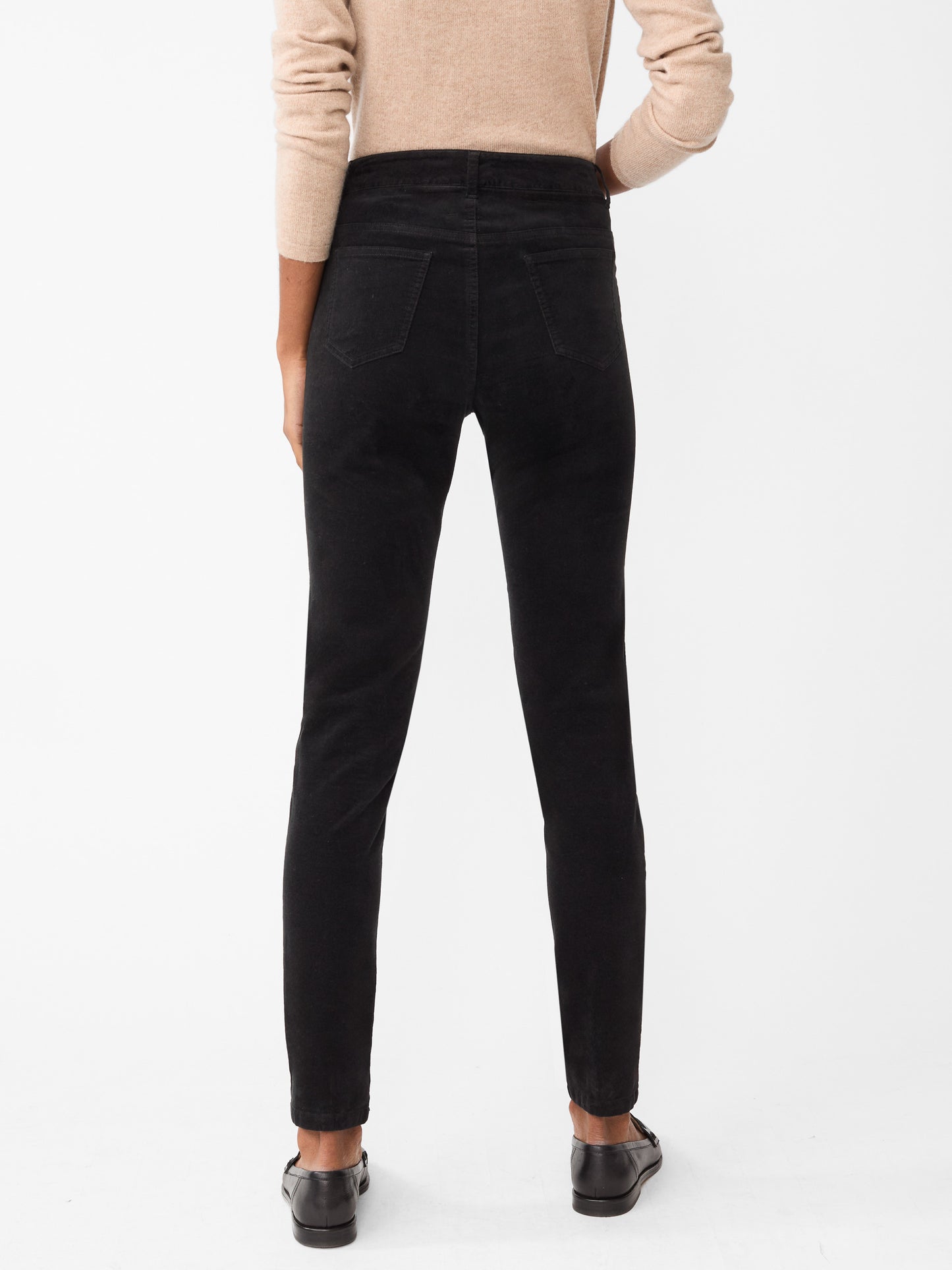 Model wearing J.McLaughlin Watson jeans in black made with velveteen.