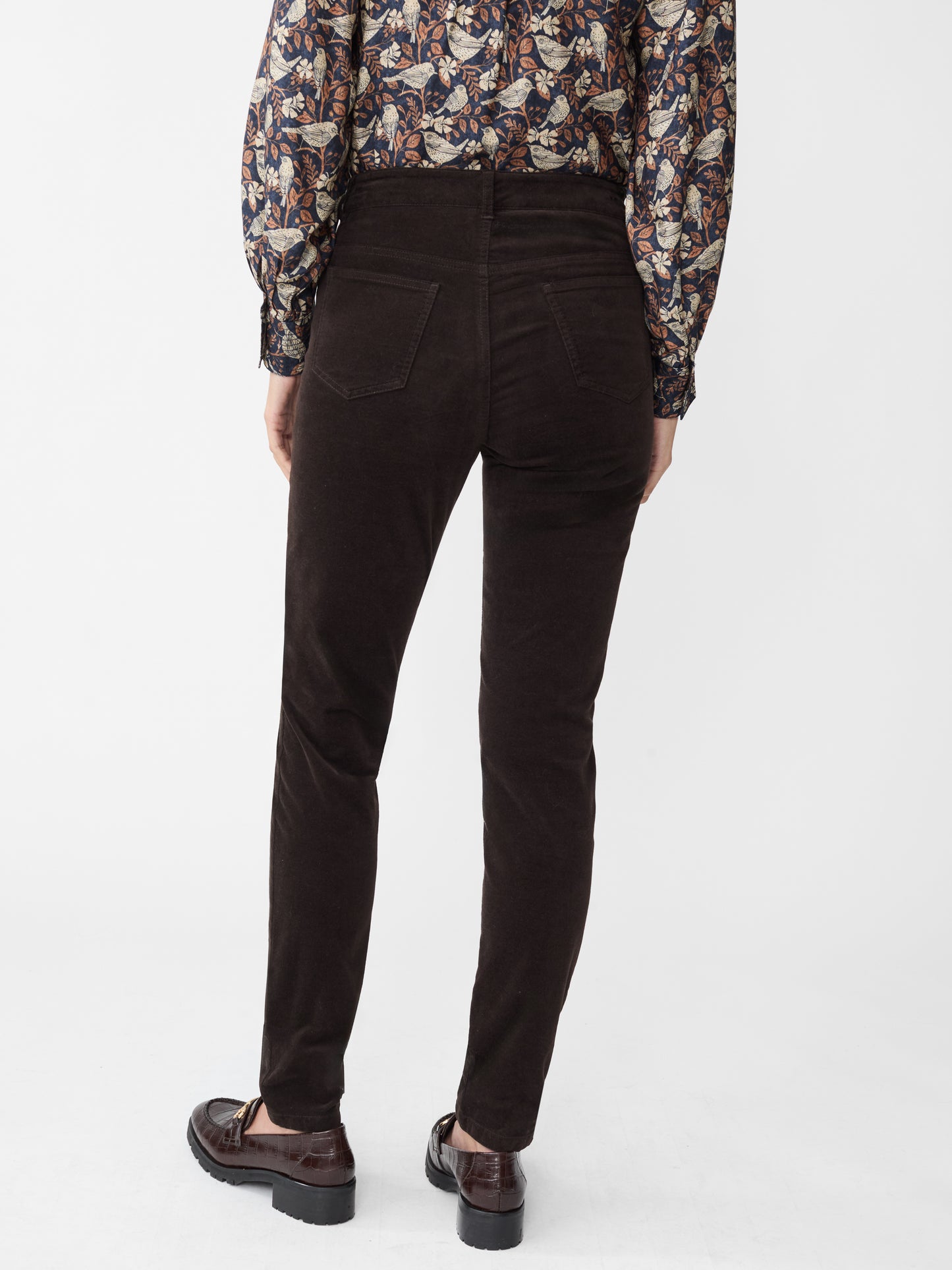 Model wearing J.McLaughlin Watson jeans in dark chocolate made with velveteen.